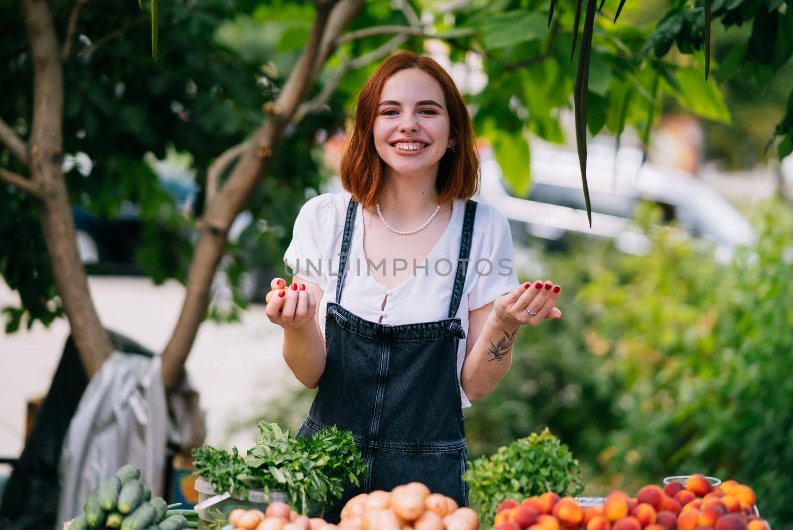 Woman seller at the counter with vegetables.