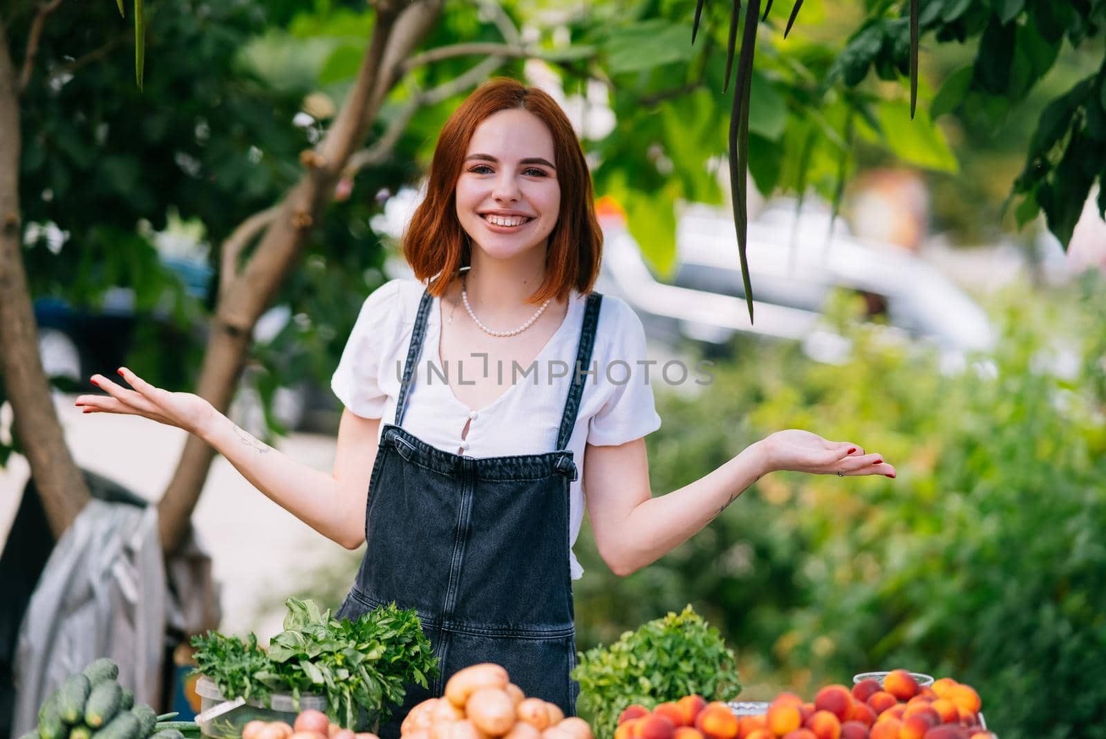 Woman seller at the counter with vegetables.