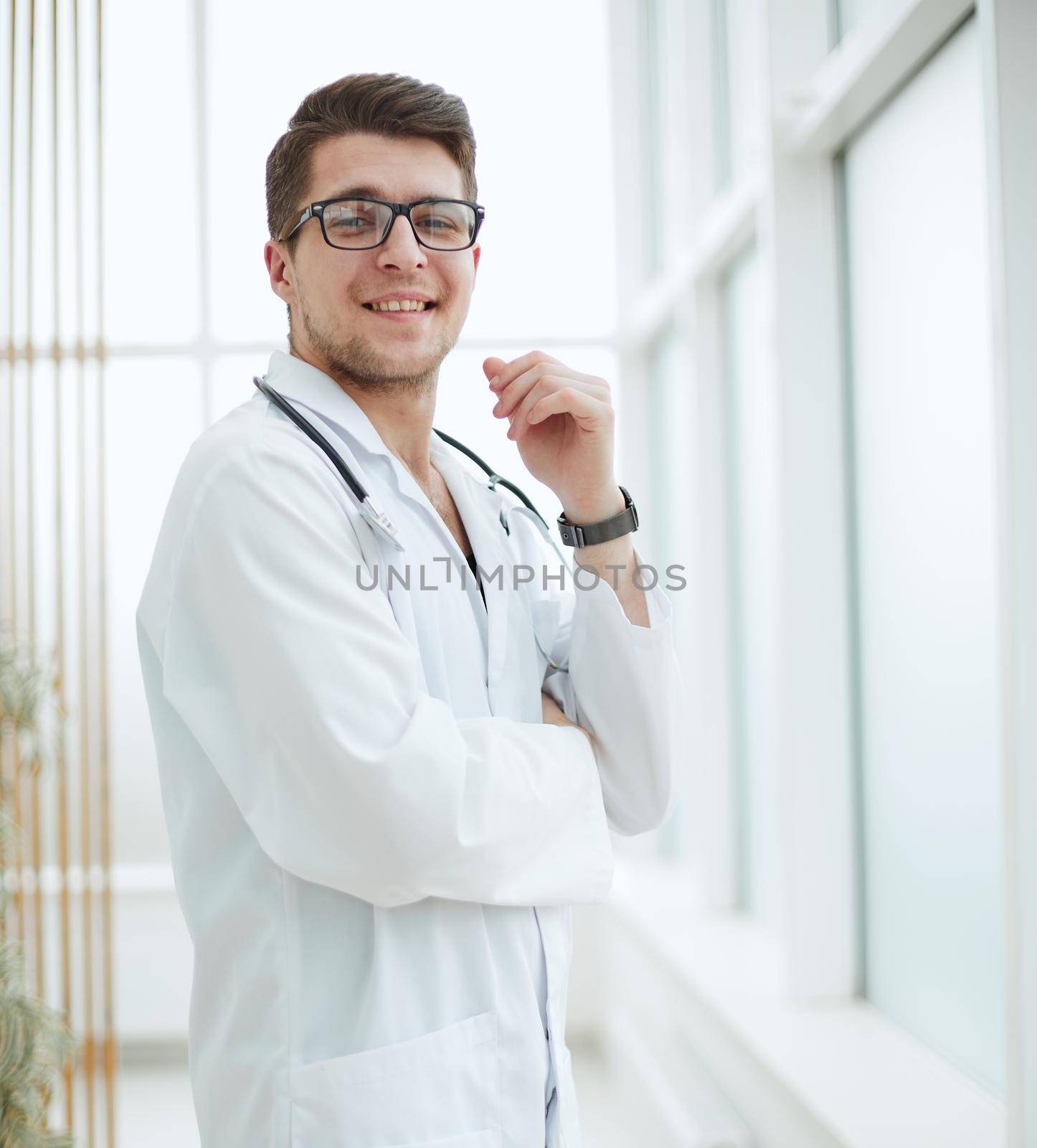 Portrait of young, doctor sitting in medical office