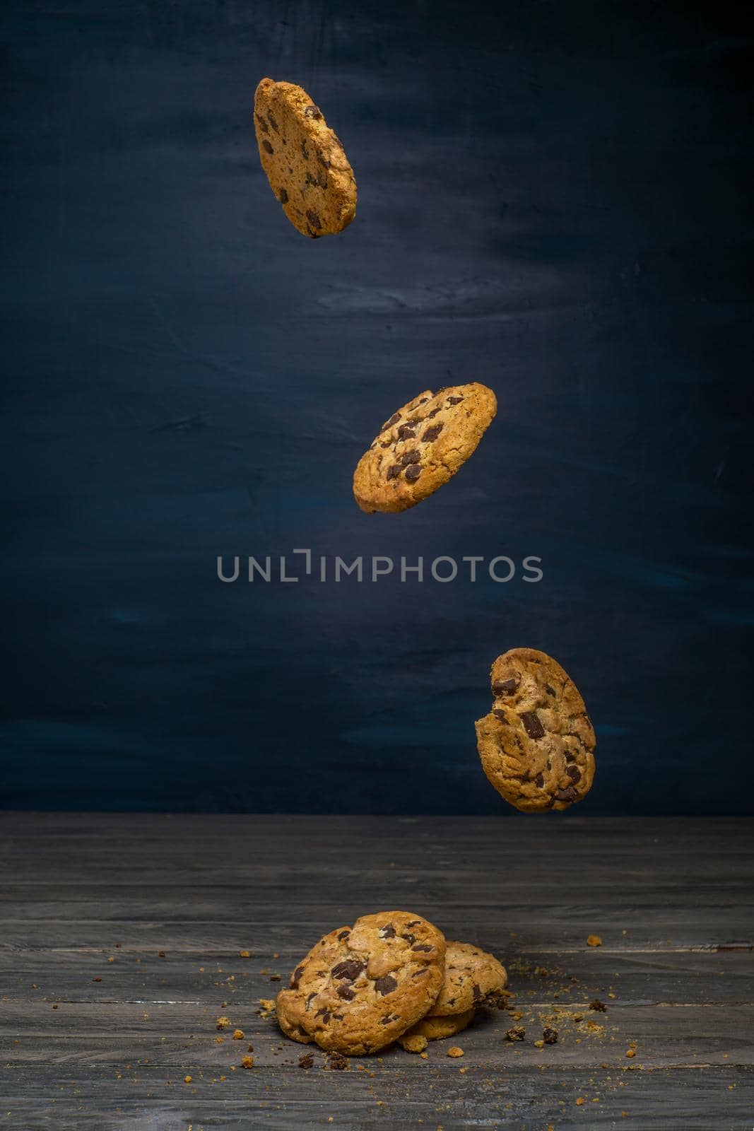 chocolate cookies levitating on black background