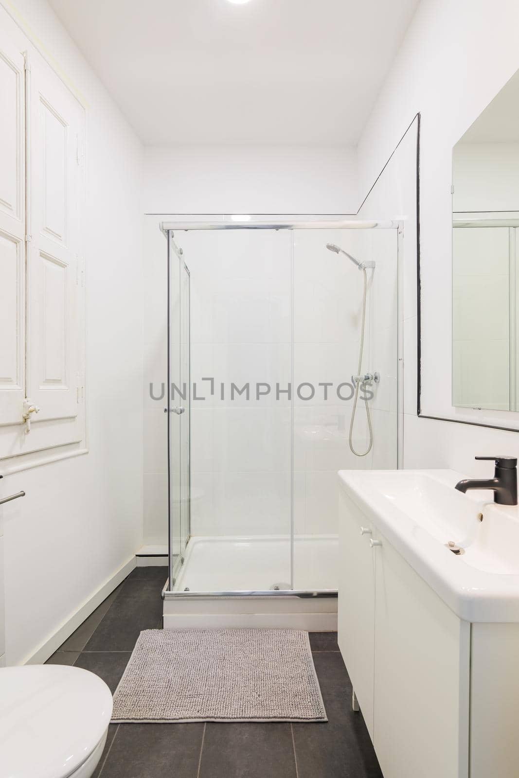 Modern white bathroom with shower cabin in renovated apartment. by apavlin