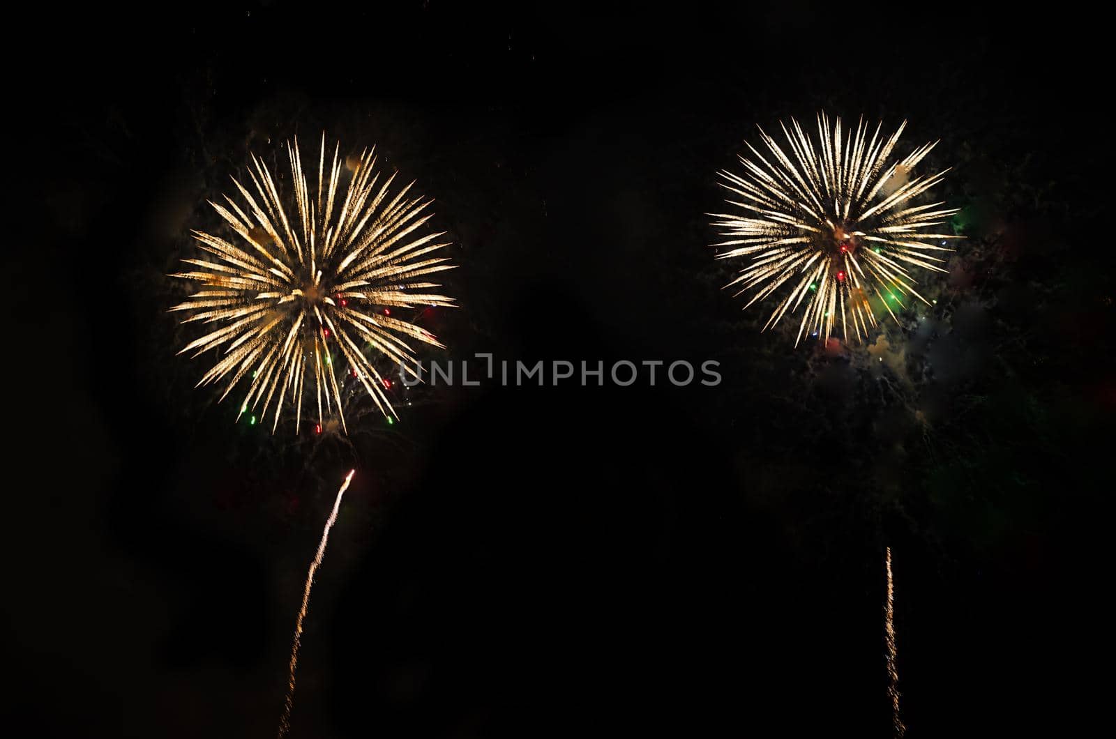 Two fireworks on night sky.