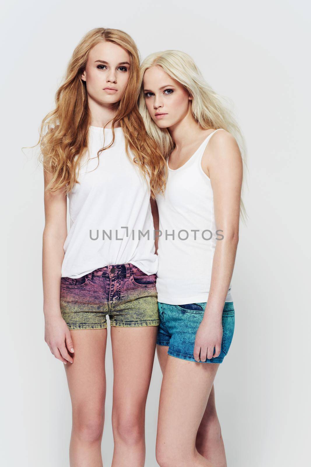 Effortless natural beauty and style. Studio portrait of two young models against a white background. by YuriArcurs