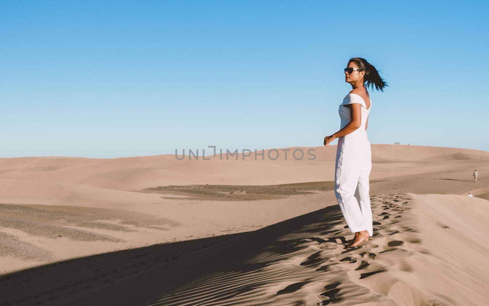 young woman at the dessert of Maspalomas sand dunes Gran Canaria during vacation Canary Islands by fokkebok