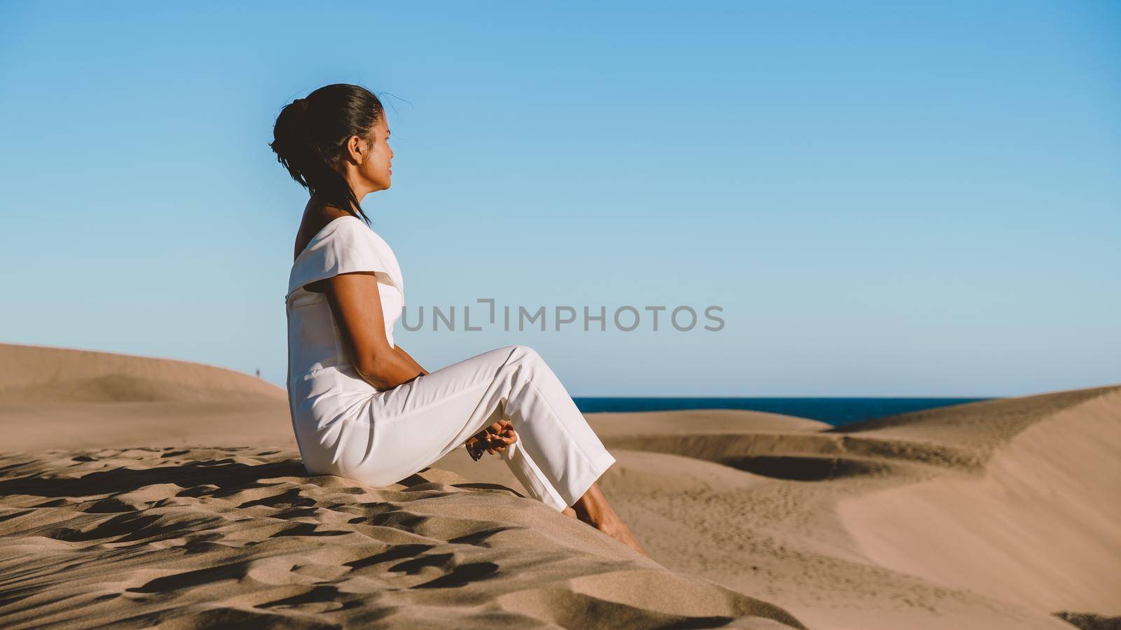 young woman at the dessert of Maspalomas sand dunes Gran Canaria during vacation Canary Islands by fokkebok