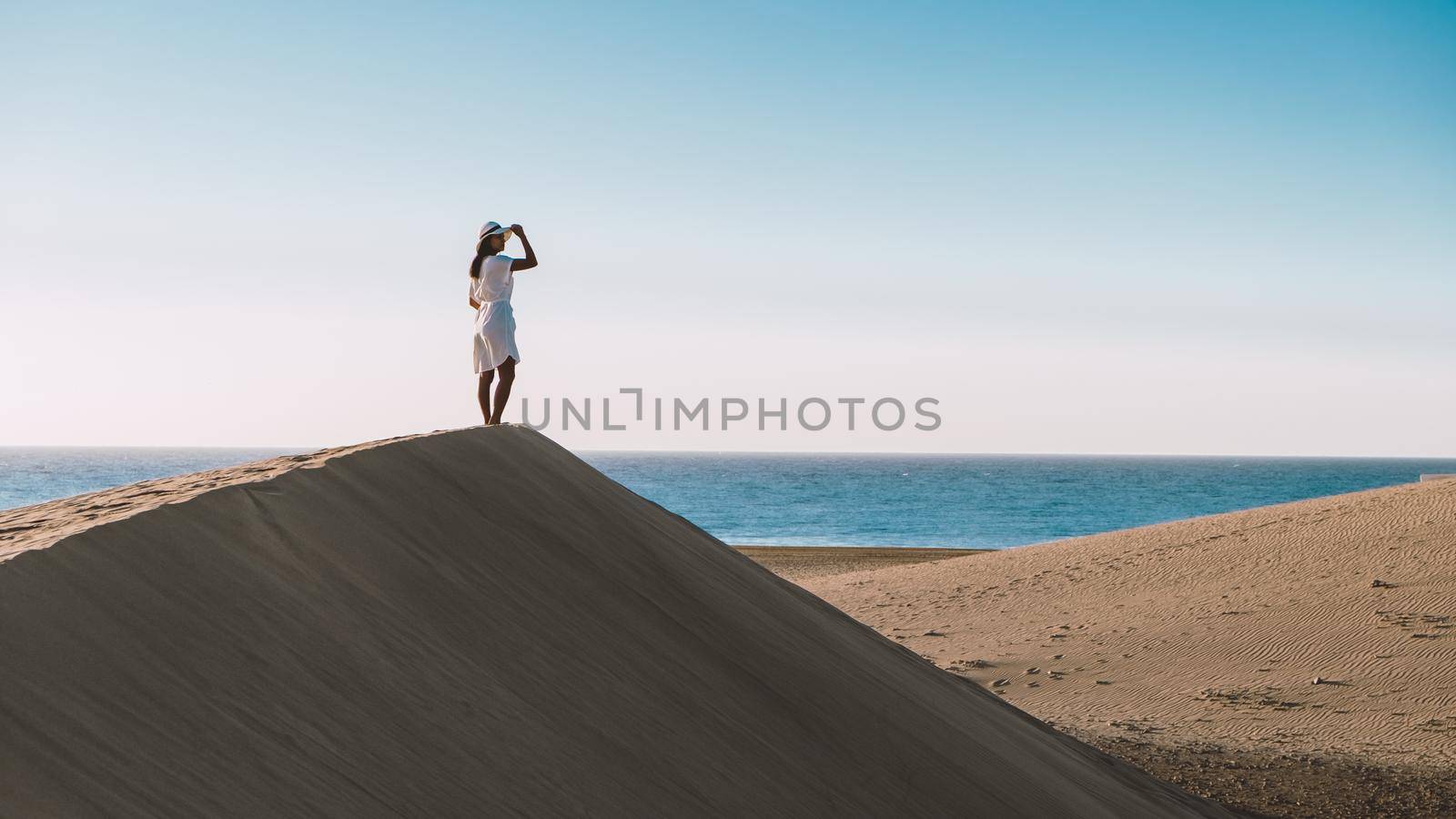 young woman at the dessert of Maspalomas sand dunes Gran Canaria during vacation at the Canary Islands. in Spain, Gran Canaria sand dunes