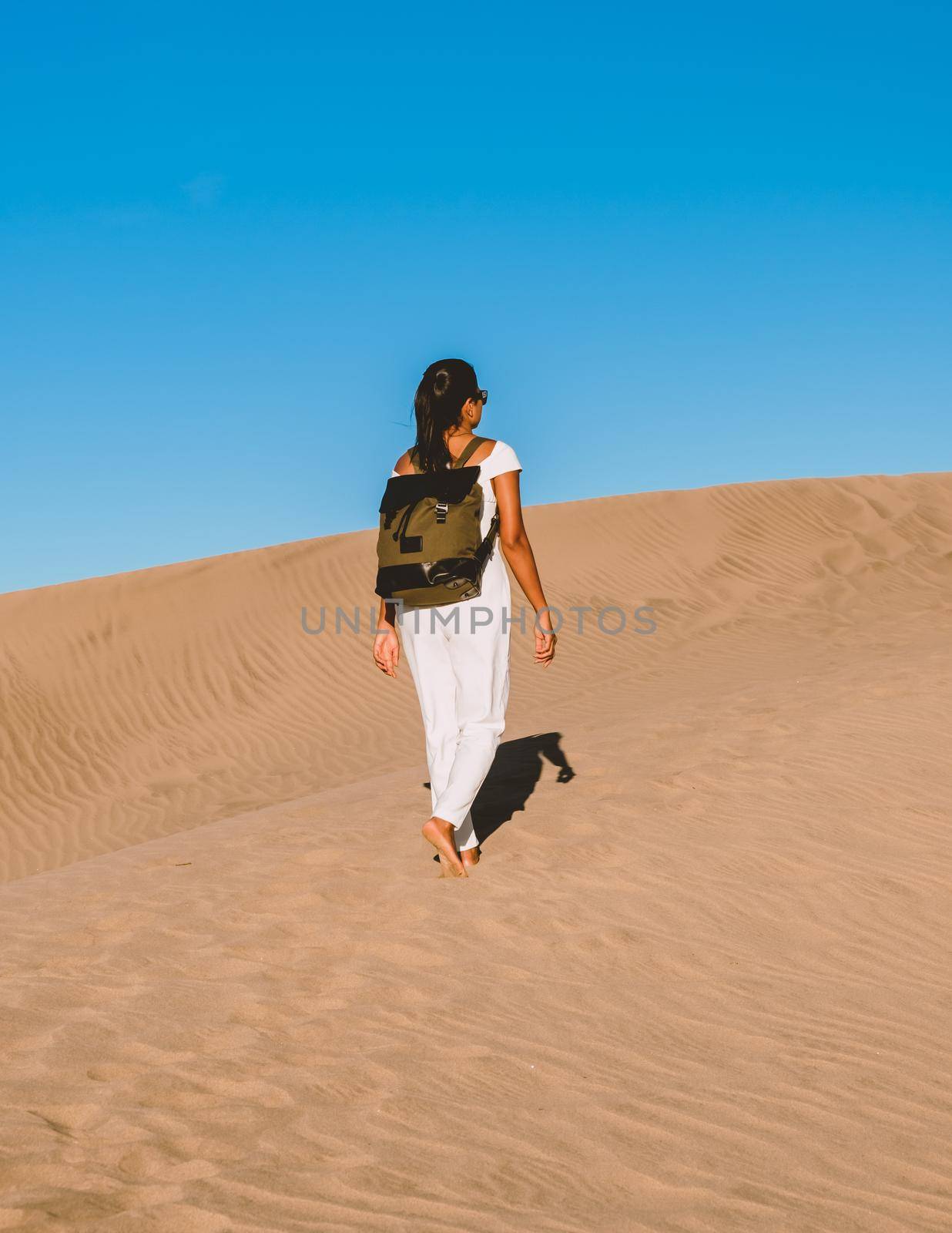 young woman at the dessert of Maspalomas sand dunes Gran Canaria during vacation at the Canary Islands. in Spain, Gran Canaria sand dunes