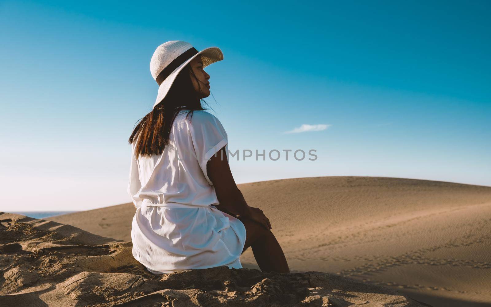 young woman at the dessert of Maspalomas sand dunes Gran Canaria during vacation at the Canary Islands. in Spain, Gran Canaria sand dunes