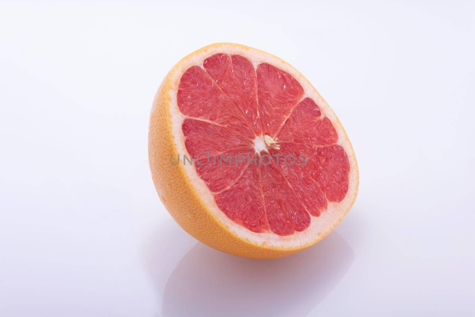 Red grapefruit, cut in half, fresh natural, juicy fruit on white