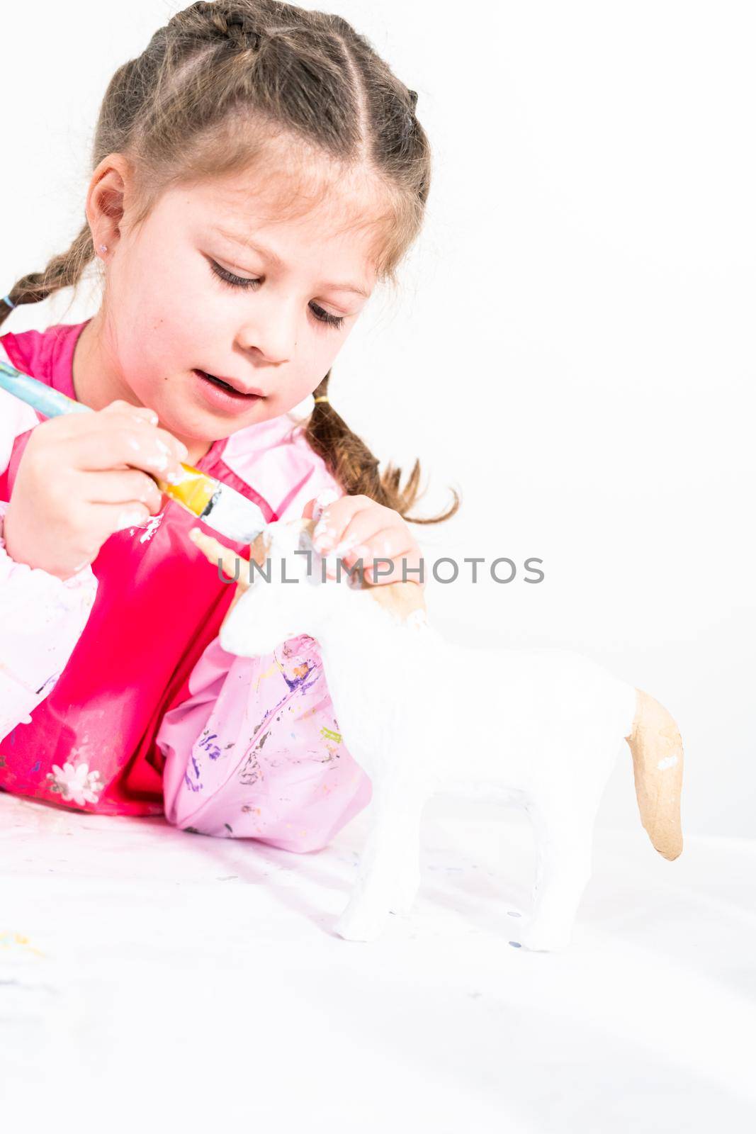 Little girl working on her art project for distance learning at home during COVID-19 pendemic.