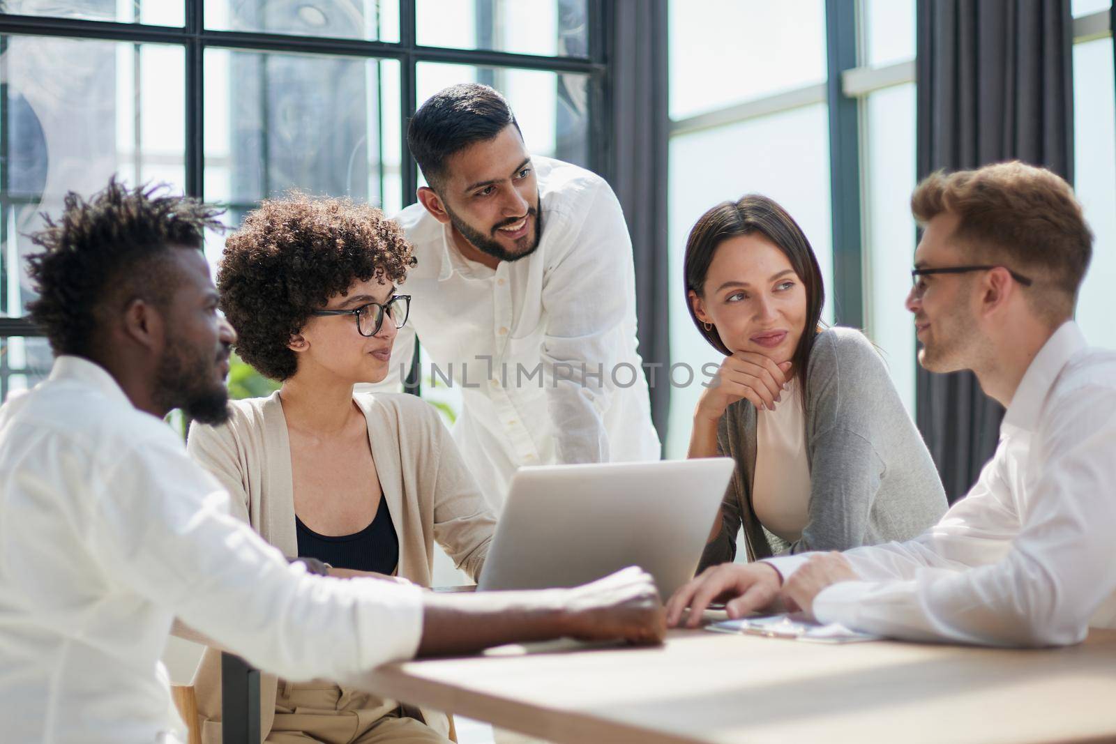 Employees working at computer together, discussing content by Prosto
