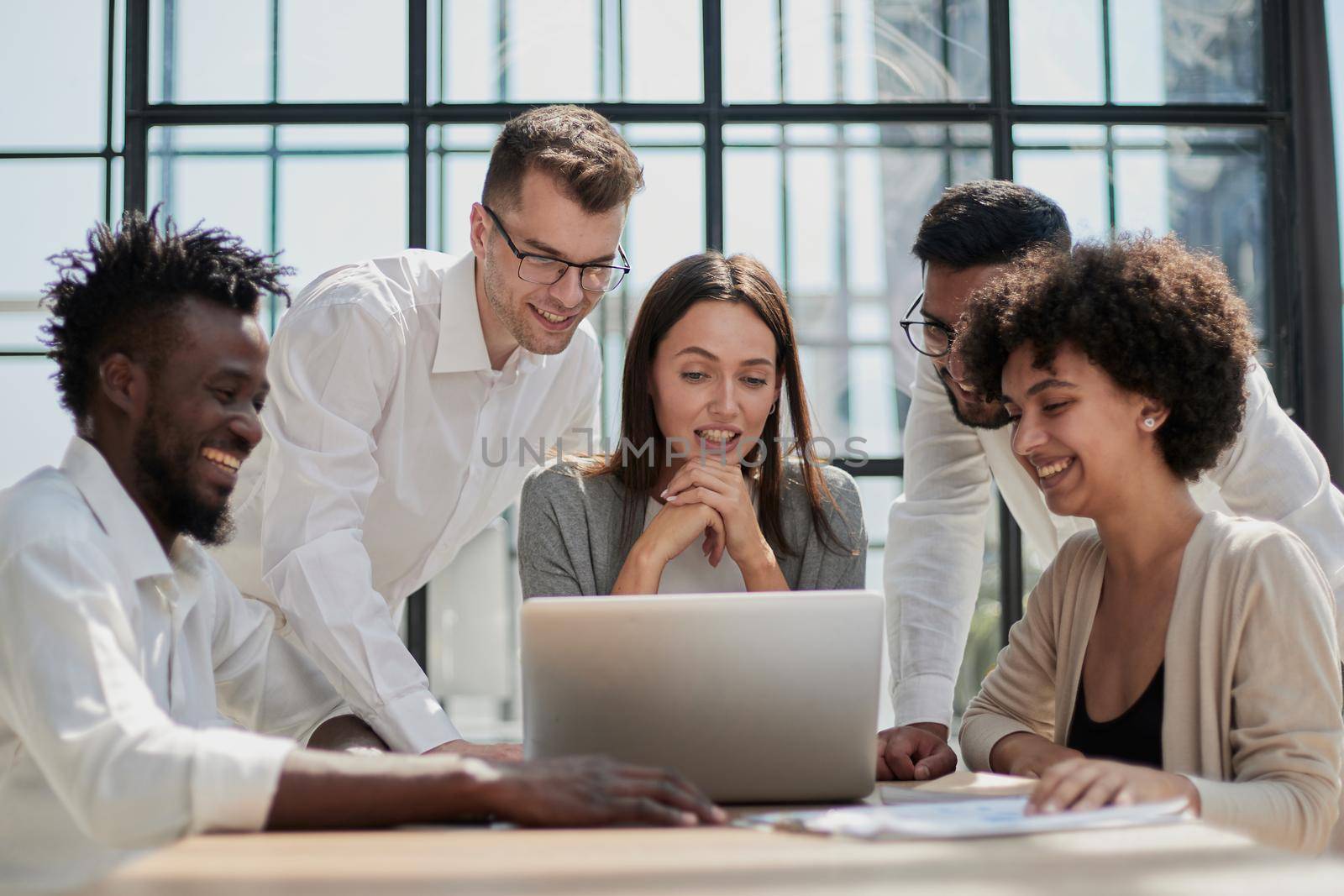 Employees working at computer together, discussing content by Prosto