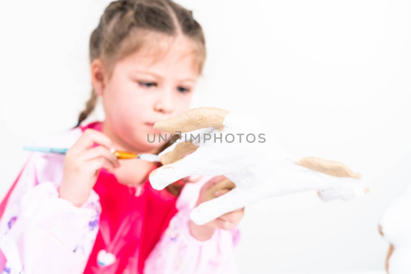 Little girl working on her art project for distance learning at home during COVID-19 pendemic.