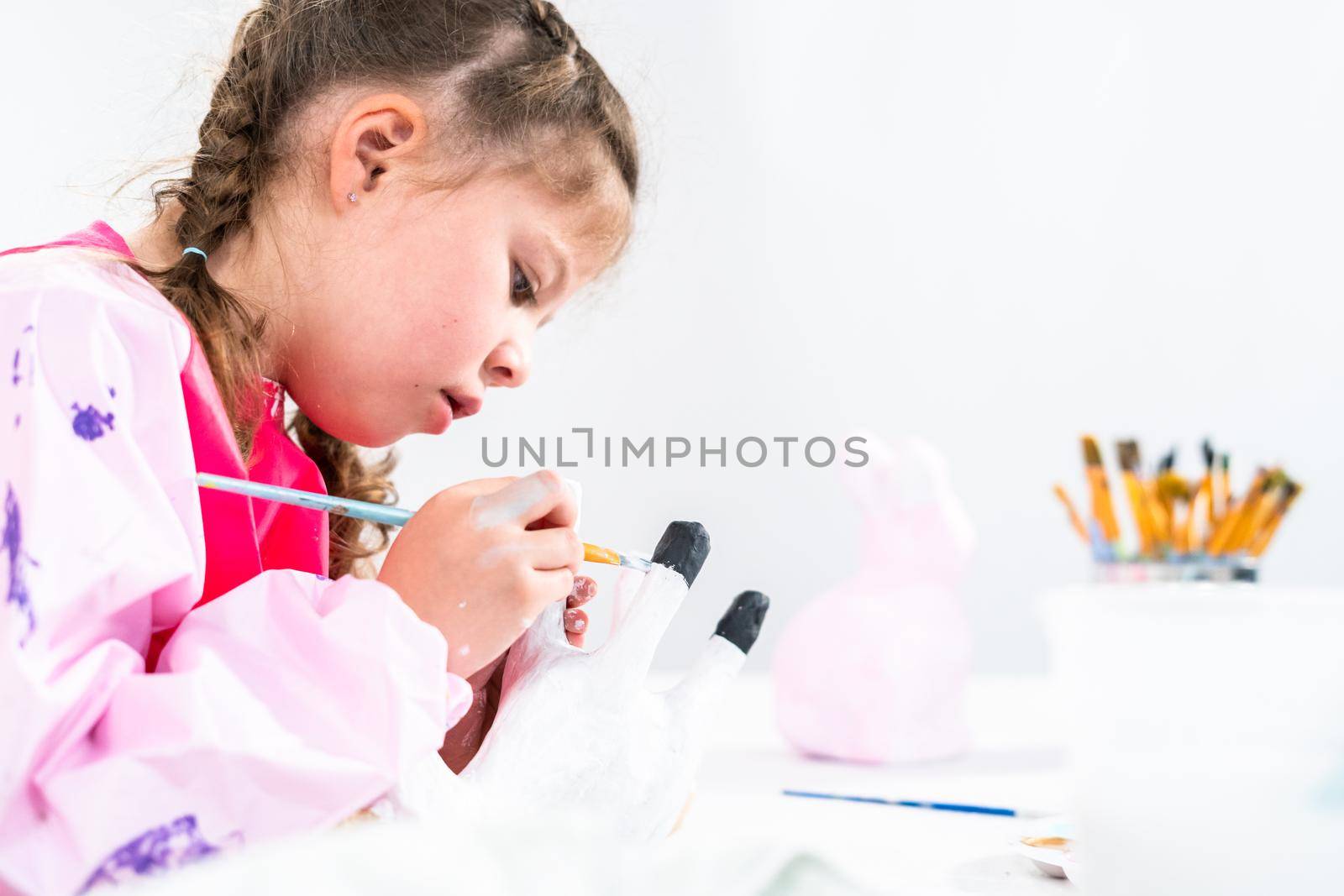 Little girl working on her art project for distance learning at home during COVID-19 pendemic.