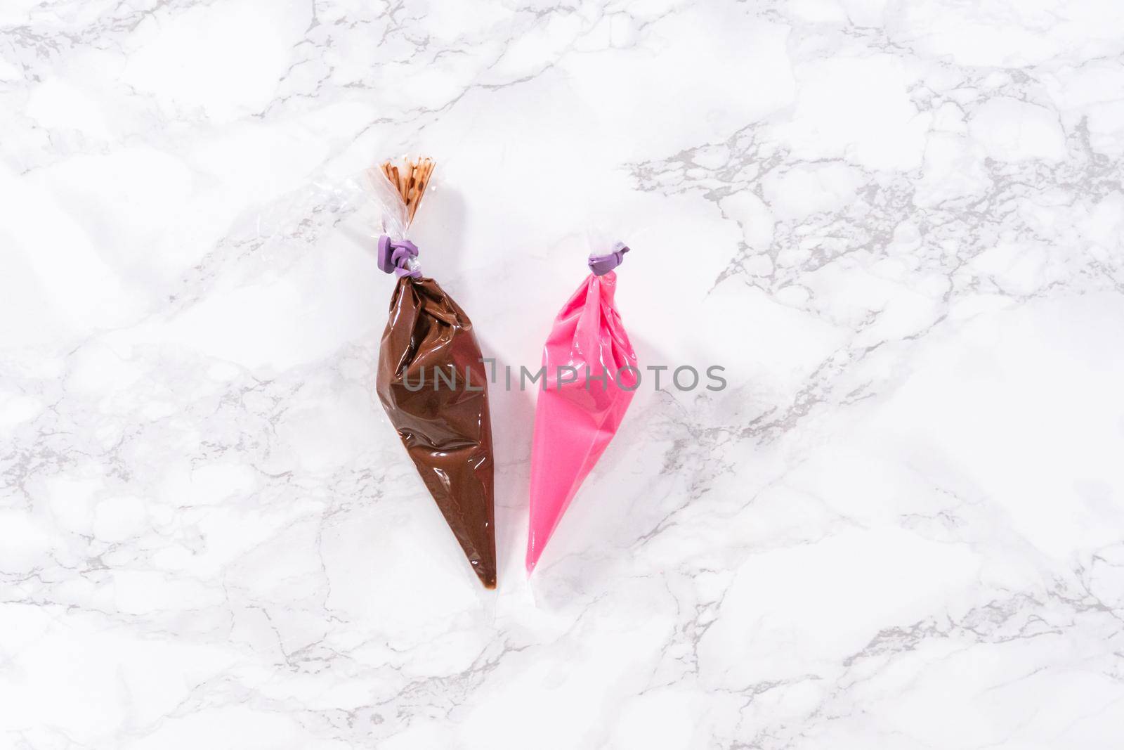 Flat lay. Melted chocolate in piping bags ready for drizzling over chocolate-covered strawberries.