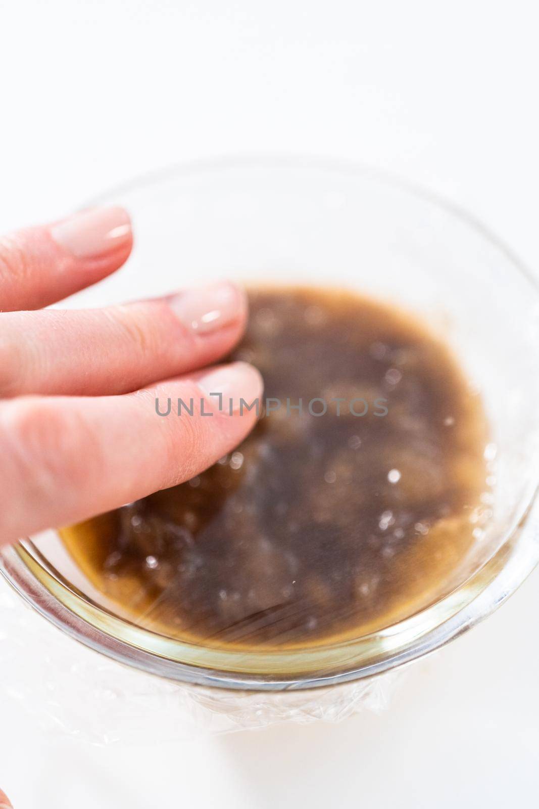 Mashed overripe banana in a glass mixing bowl.