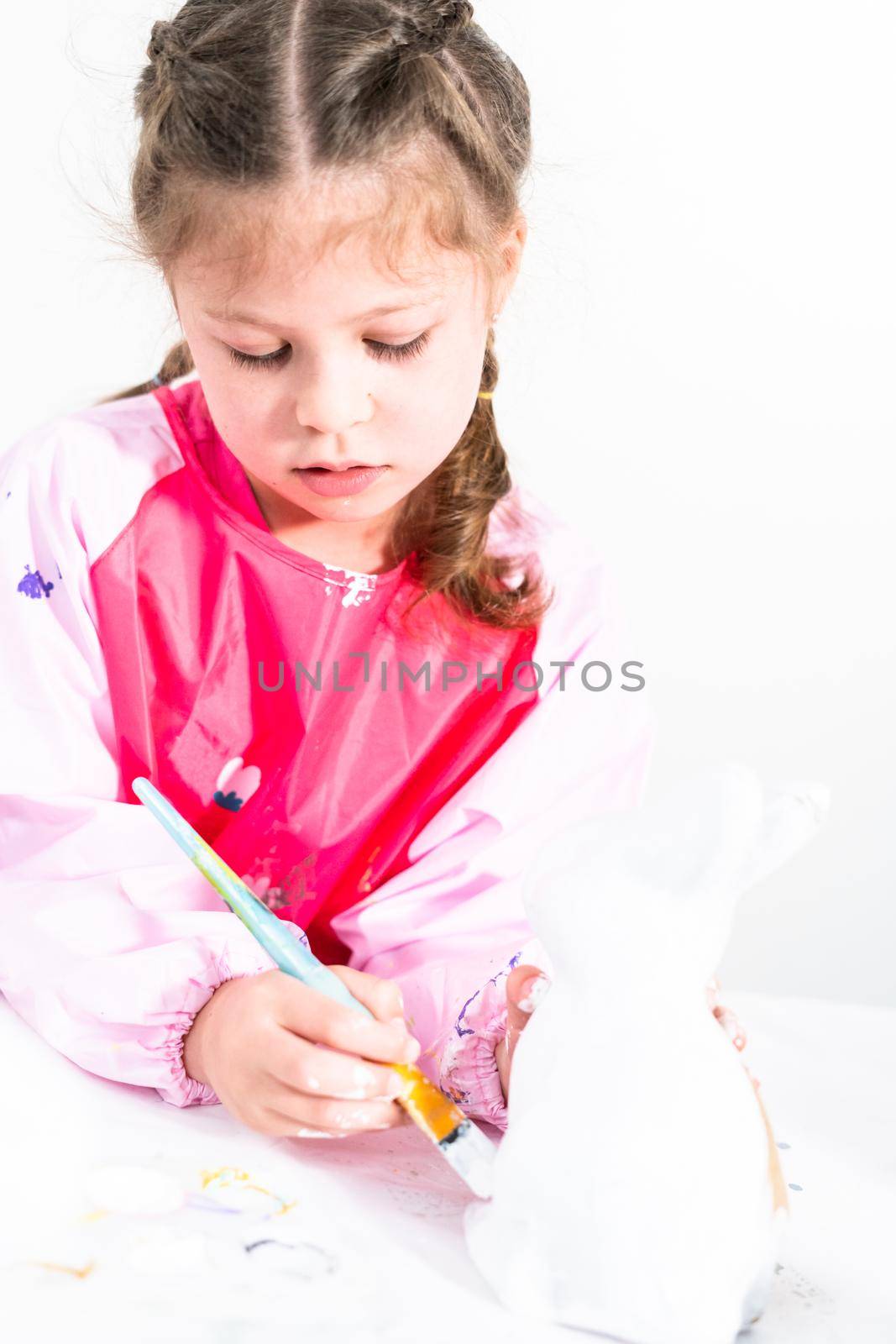 Little girl working on her art project for distance learning at home during COVID-19 pendemic.