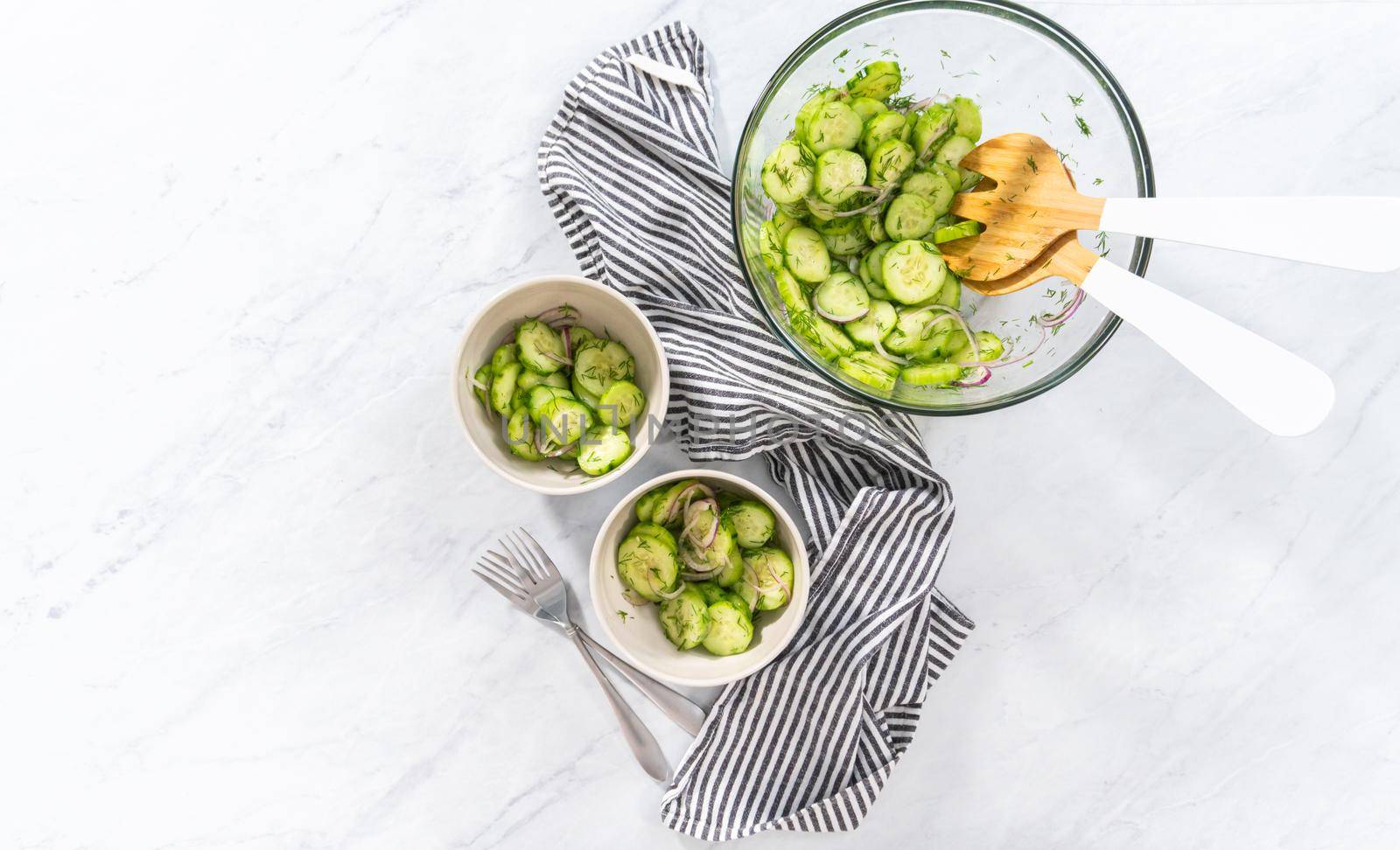 Flat lay. Summer cucumber salad in small ceramic bowls.