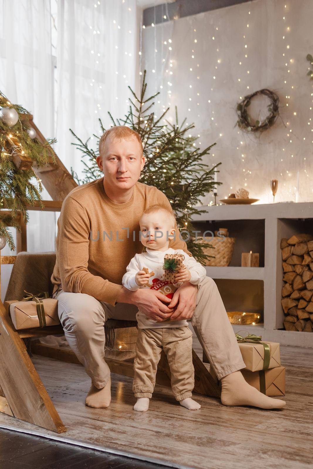 Dad and his little son in a magical Christmas atmosphere. The concept of family relations and New Year celebrations,