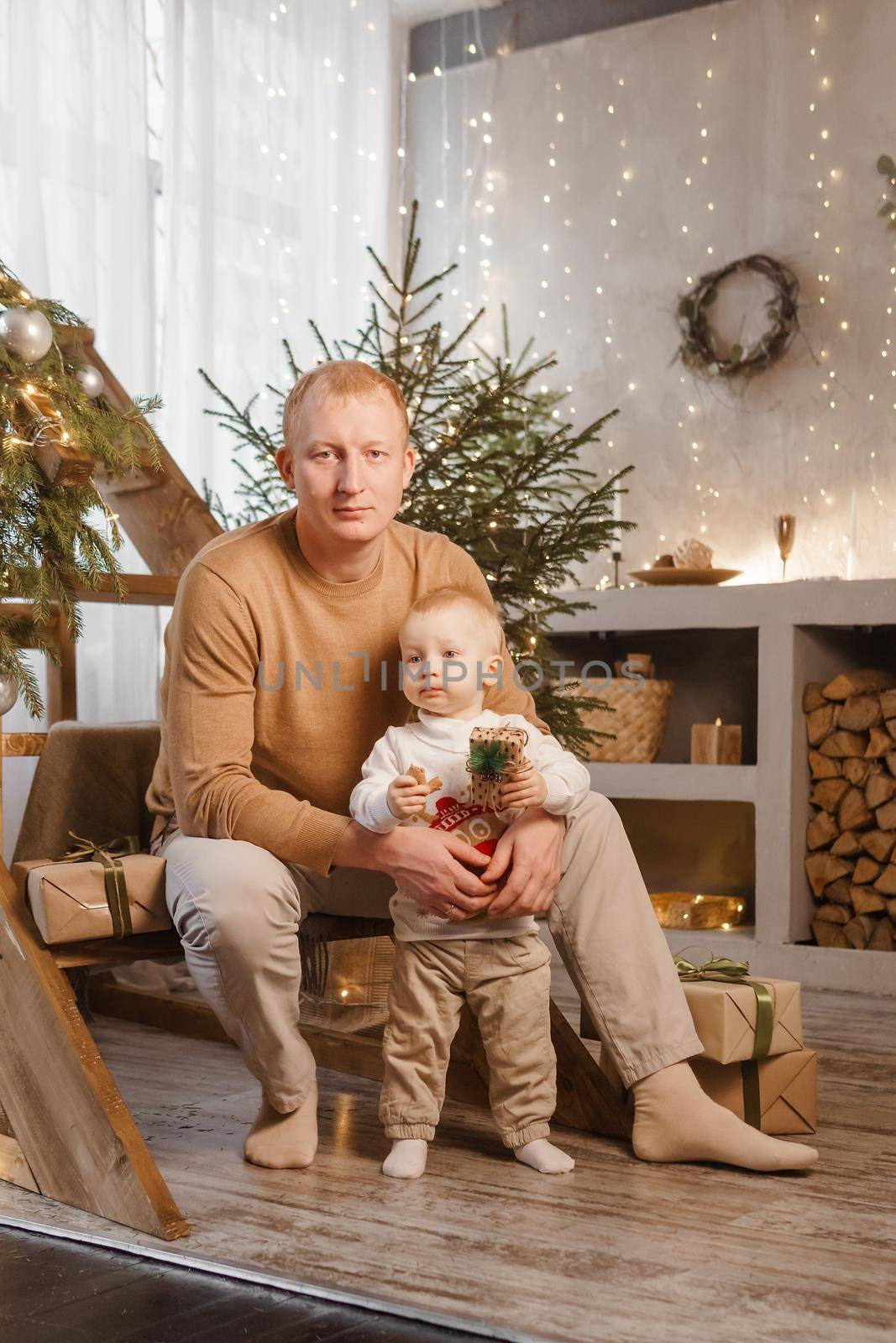 Dad and his little son in a magical Christmas atmosphere. The concept of family relations and New Year celebrations by Annu1tochka