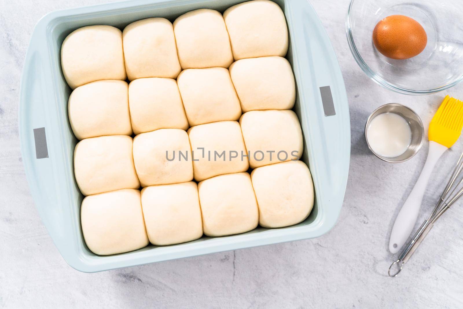 Rizing dinner rolls in an the baking pan.