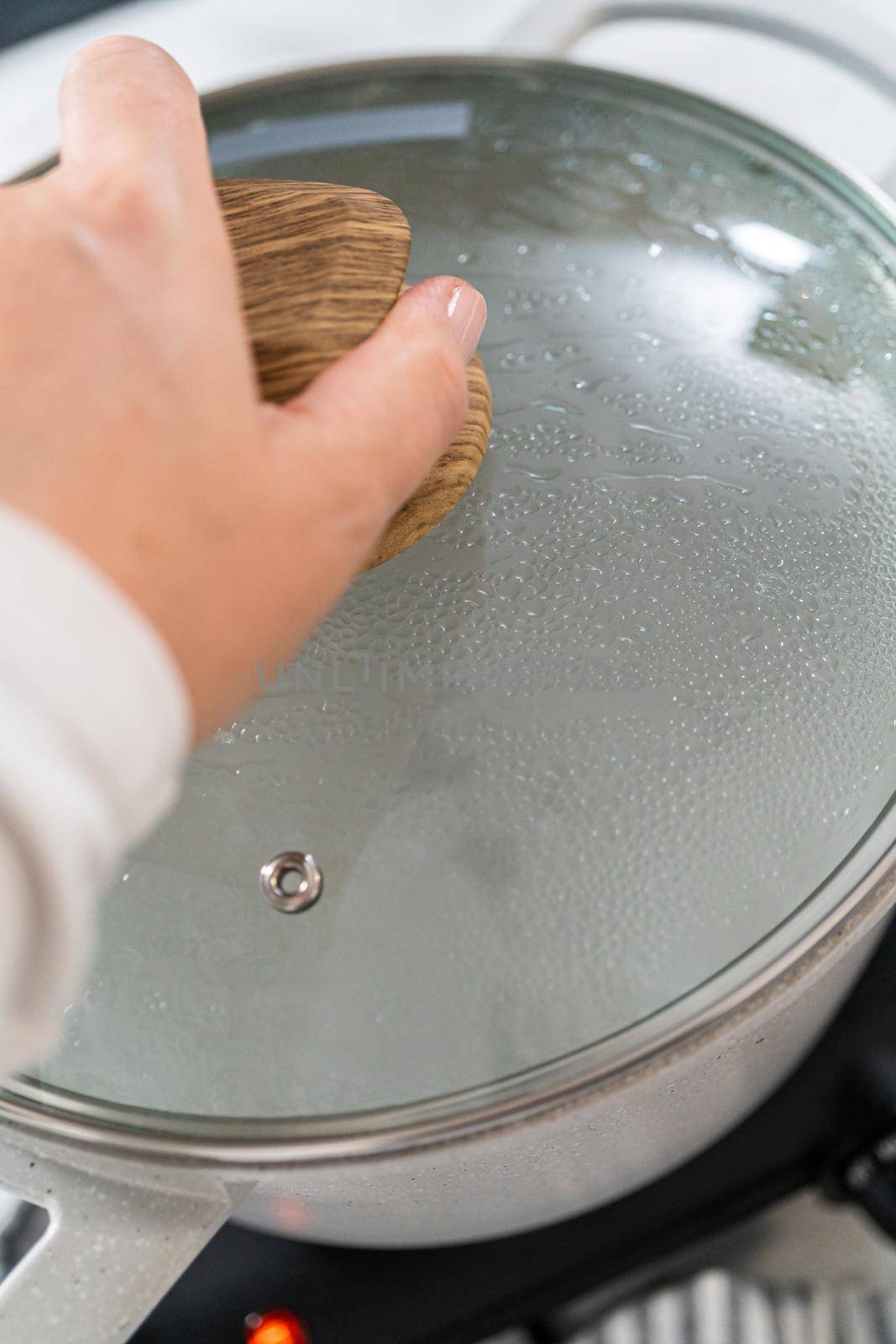Boiling water in a large cooking pot to prepare linguine pasta.