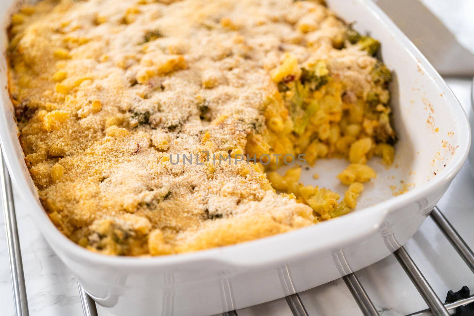 Serving freshly made macaroni and cheese with broccoli.