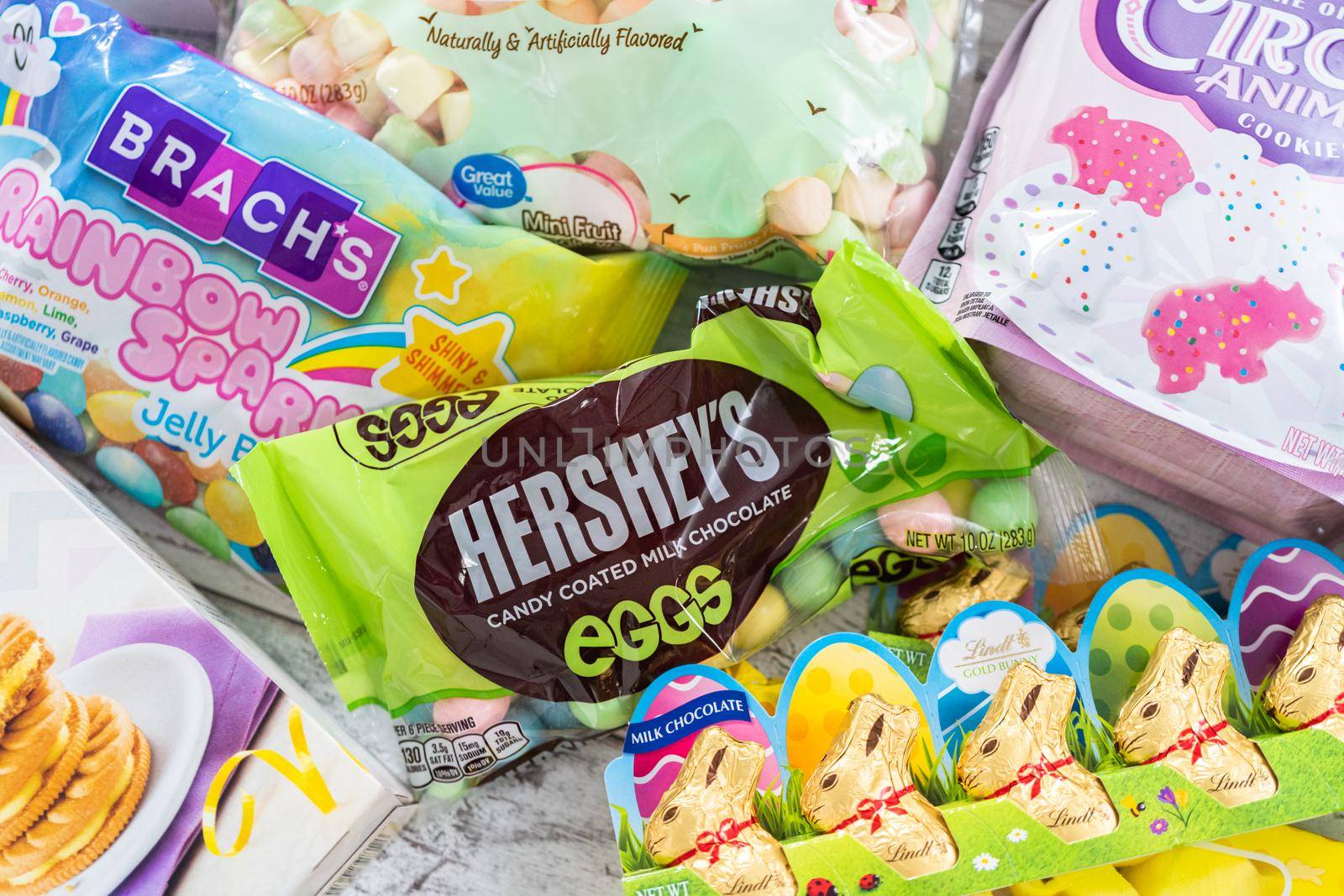 Denver, Colorado, USA-March 18, 2021 - Variety of Easter candies and cookies on the white board.