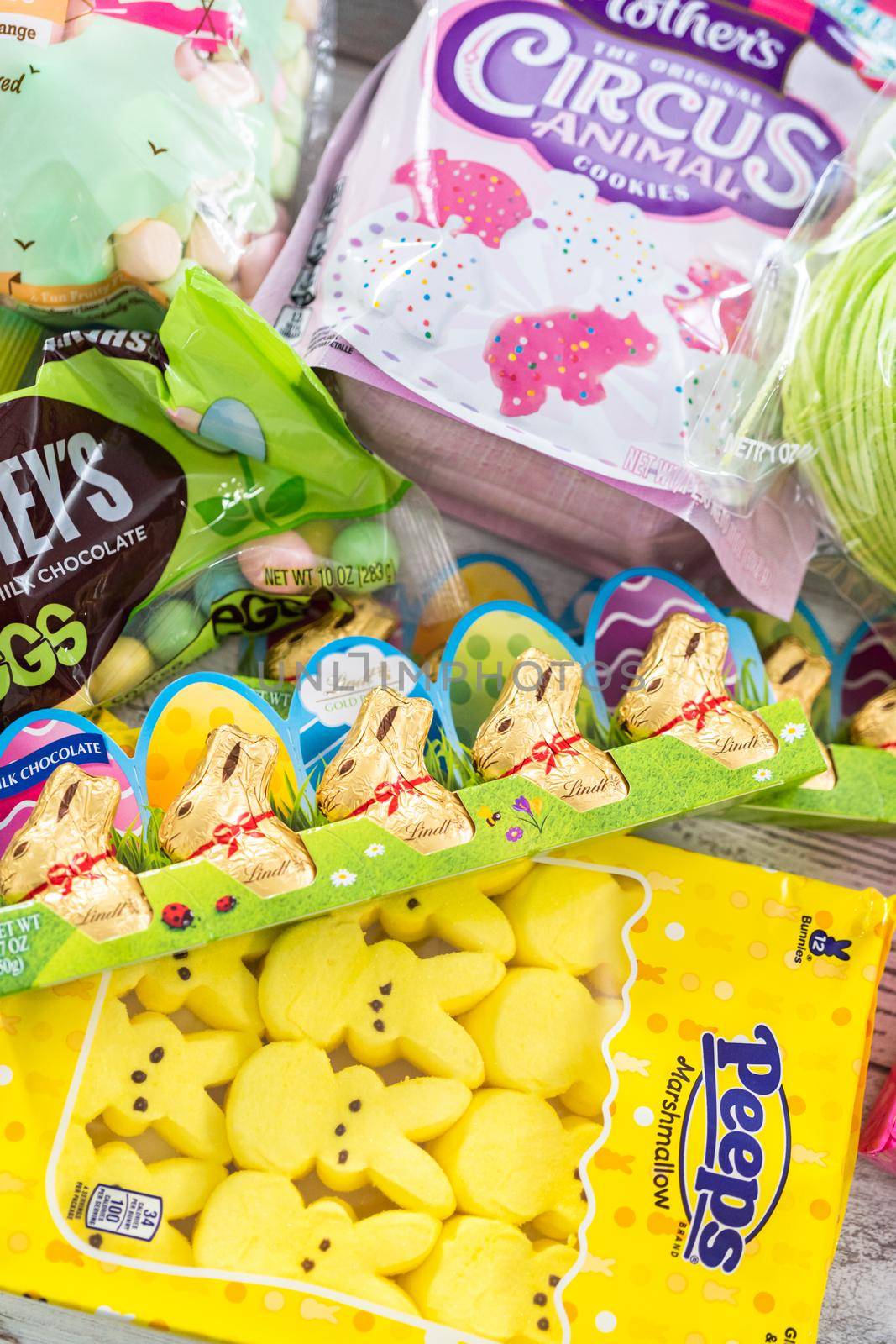 Denver, Colorado, USA-March 18, 2021 - Variety of Easter candies and cookies on the white board.