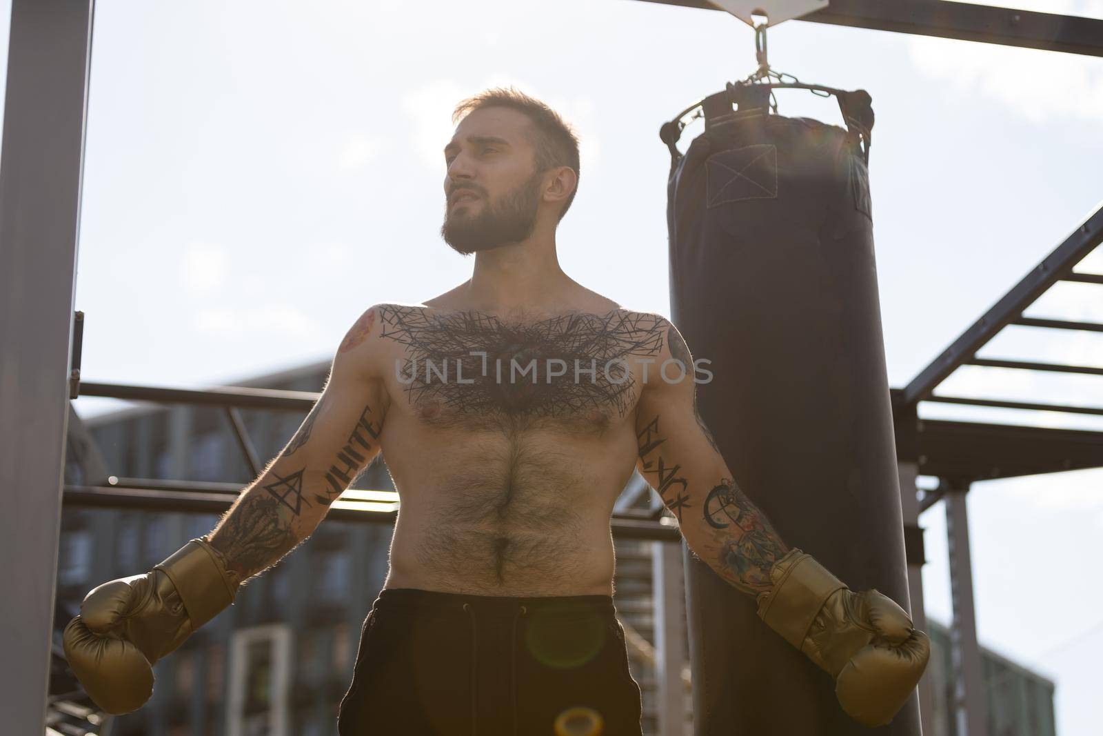 boxer athlete man putting on glove gloves prepared to train outdoors