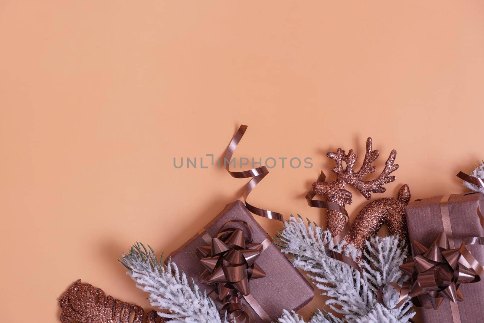 Flat lay Christmas and New Year decorations with snow pine trees with copy space top view on colored background.