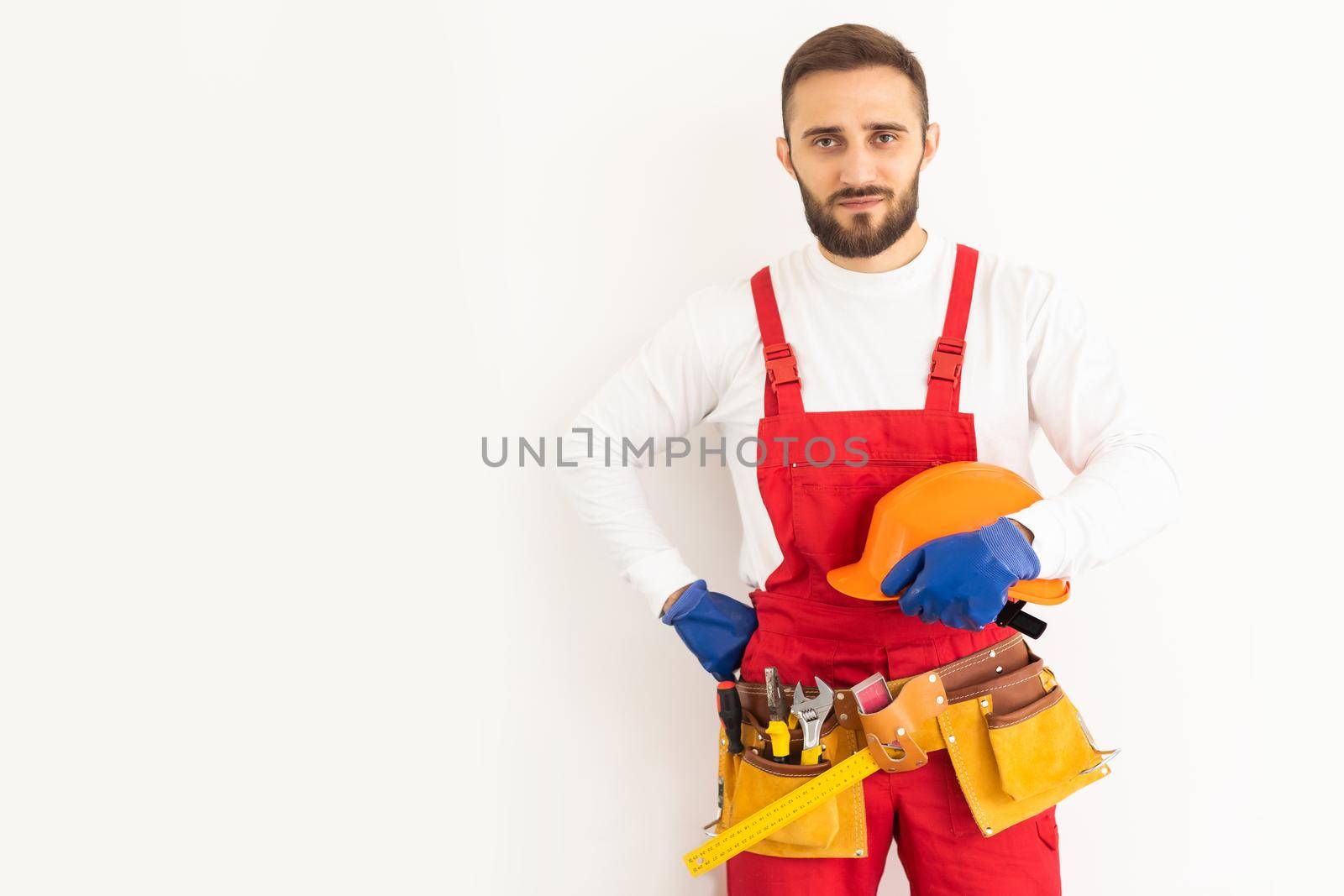 profession, construction and building - happy smiling male worker or builder over white background by Andelov13