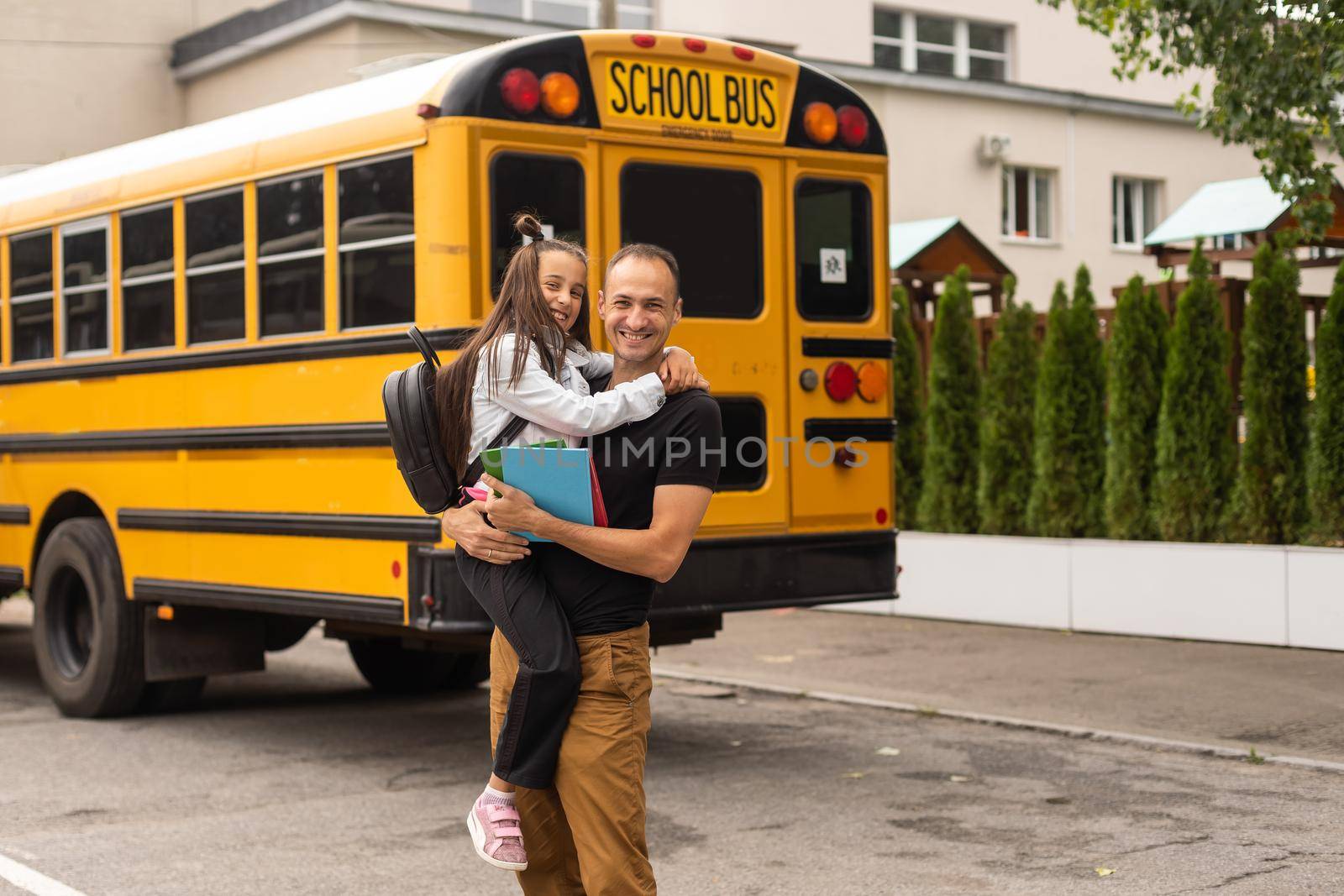 Parent taking child to school. Pupil of primary school go study with backpack outdoors. Father and son go hand in hand. Beginning of lessons. Back to school. First day of fall. Elementary student.