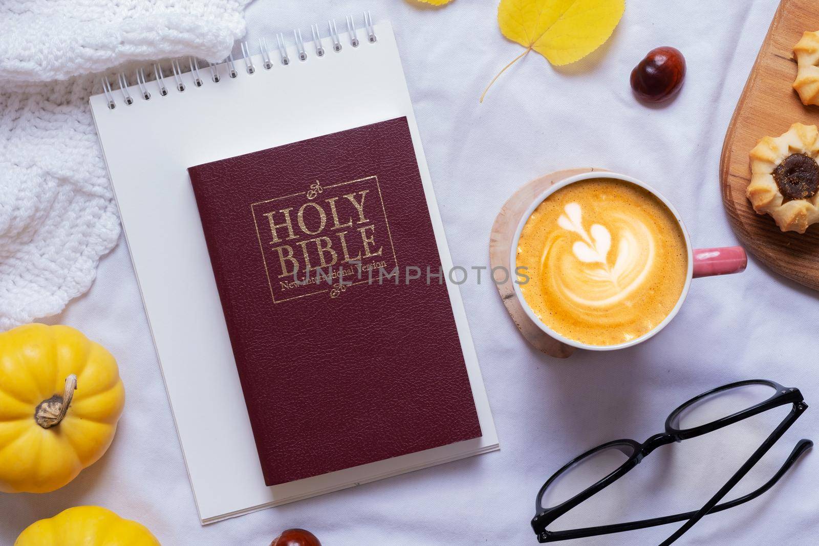 Holy Bible and latte with autumn cozy decor top view. Bible study fall concept.