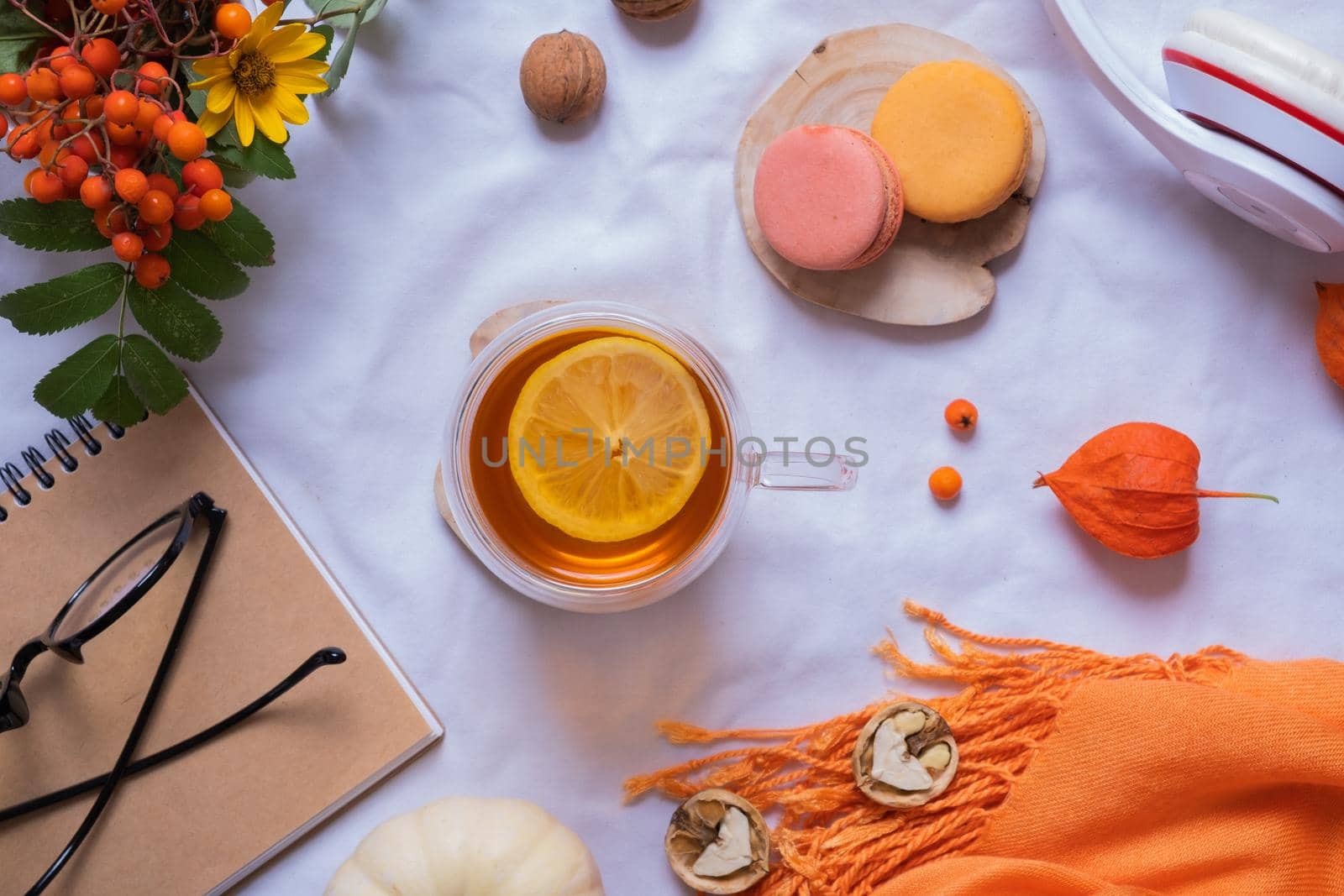 Cup of tee with autumn decor and note with headphones flat lay, top view. High quality photo