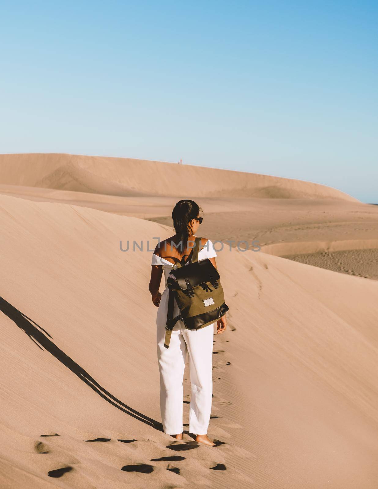 young woman at the dessert of Maspalomas sand dunes Gran Canaria during vacation Canary Islands by fokkebok