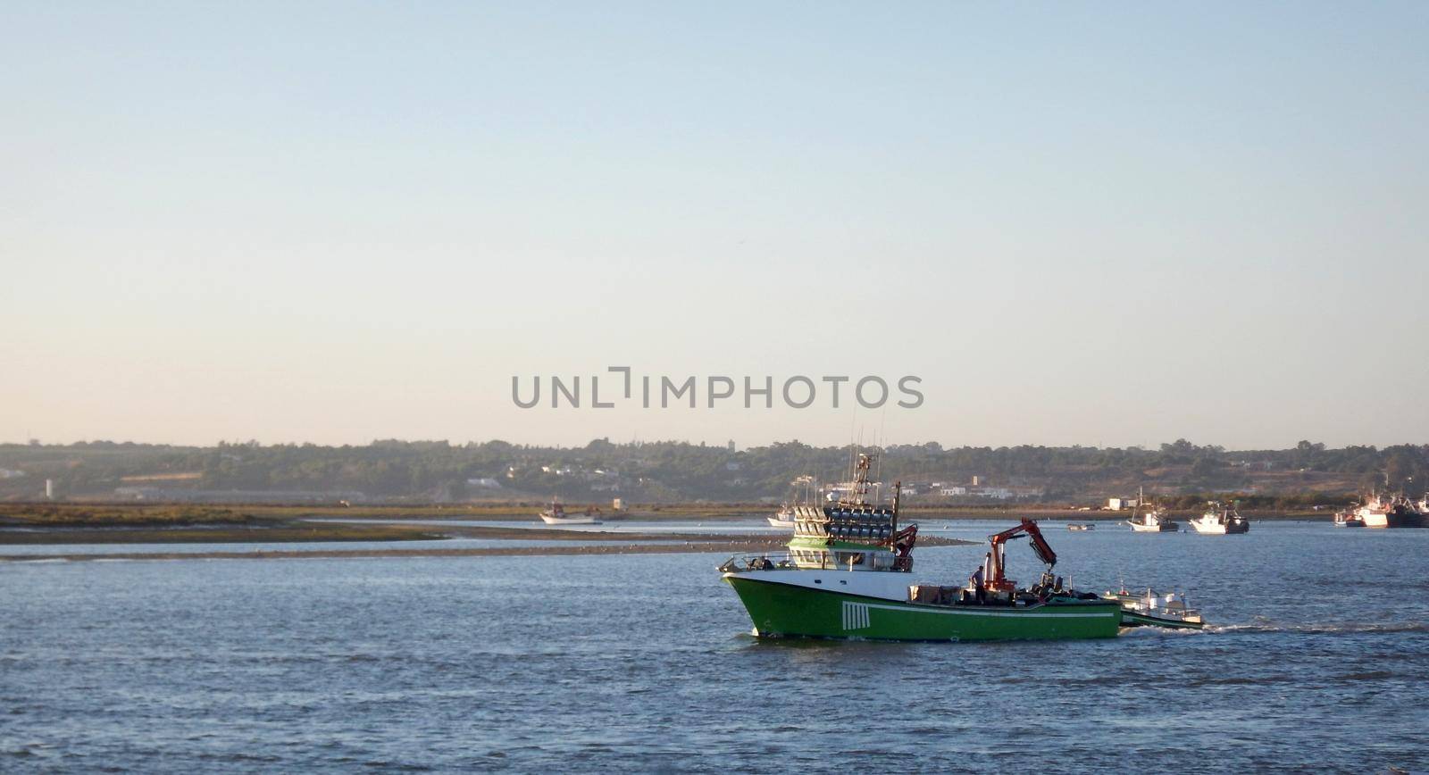 Green fishing boat sailing in the sea