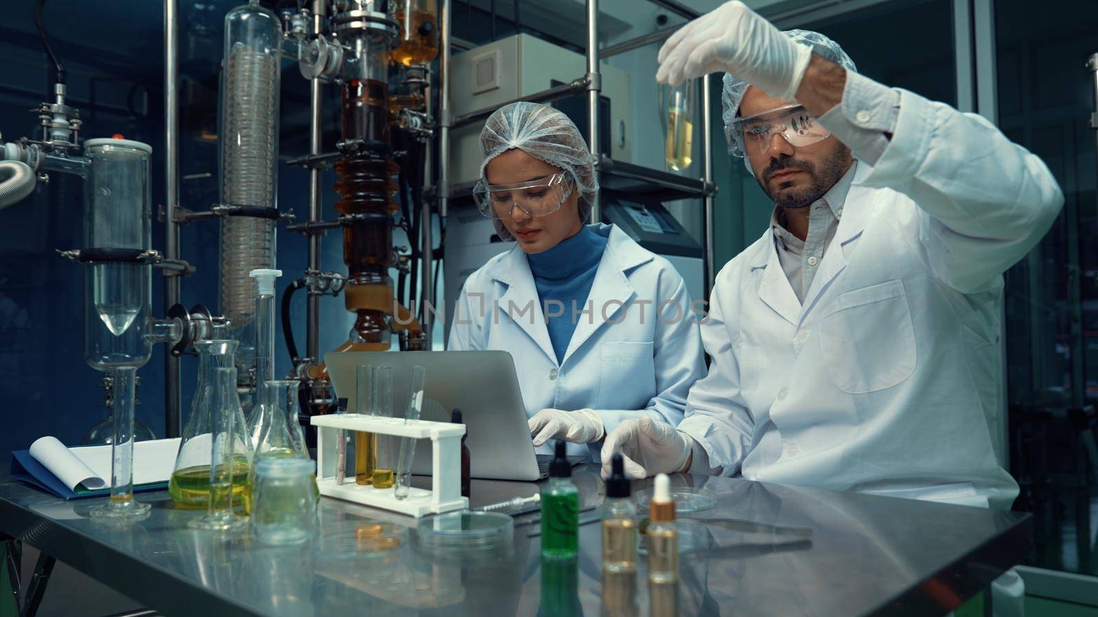 Two scientist in professional uniform working in laboratory by biancoblue