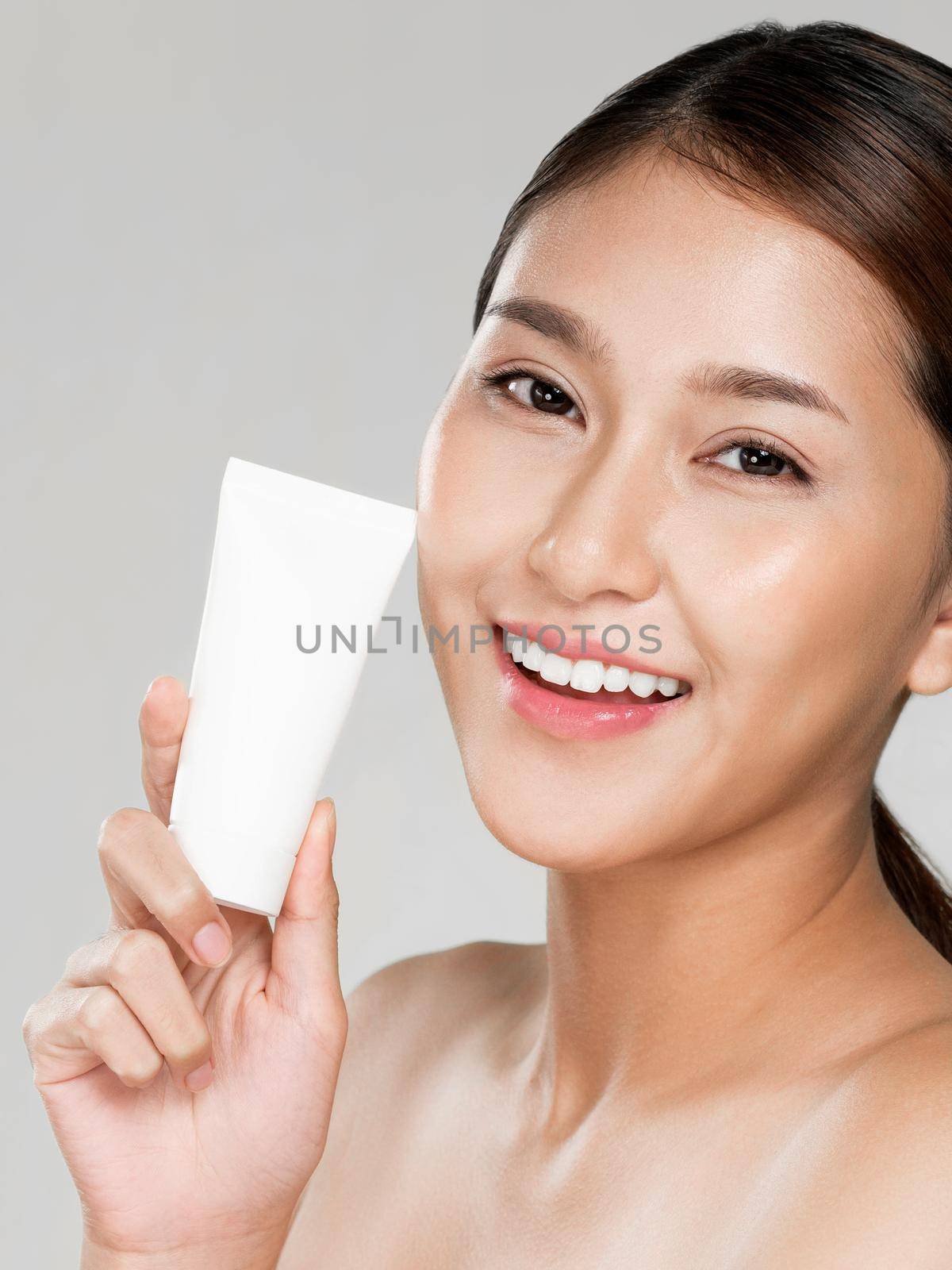 Ardent woman smiling holding mockup product for advertising text place. by biancoblue