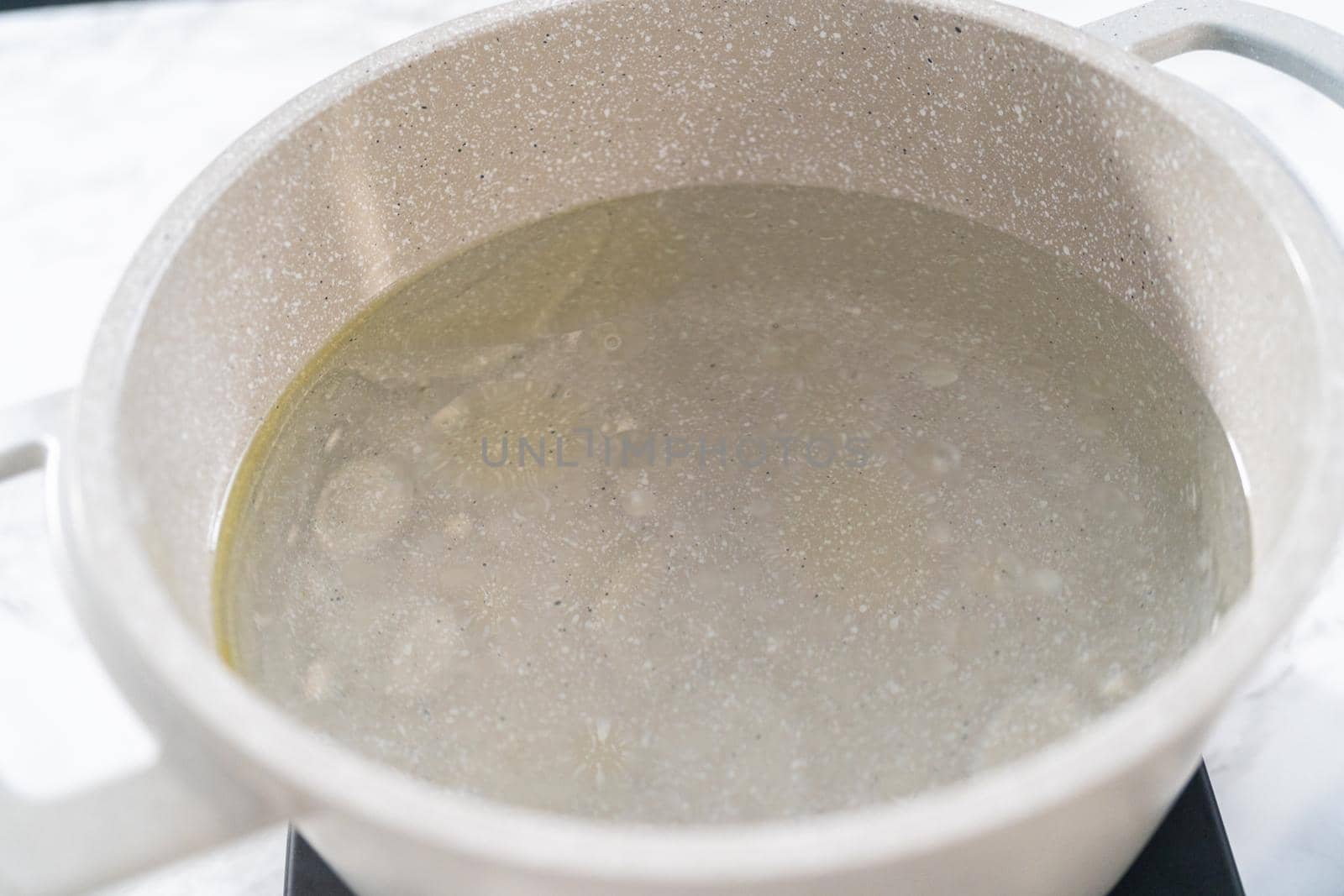 Boiling water in the cooking pot to prepare macaroni and cheese with broccoli.