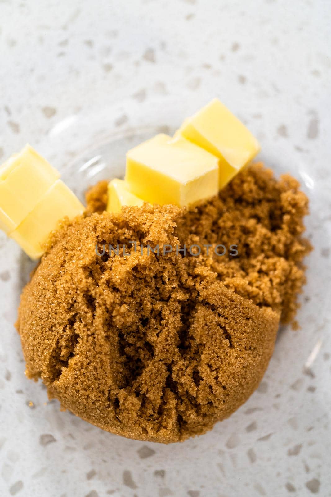 Mixing ingredients with a hand mixer in a large mixing bowl to bake dulce de leche cupcakes.