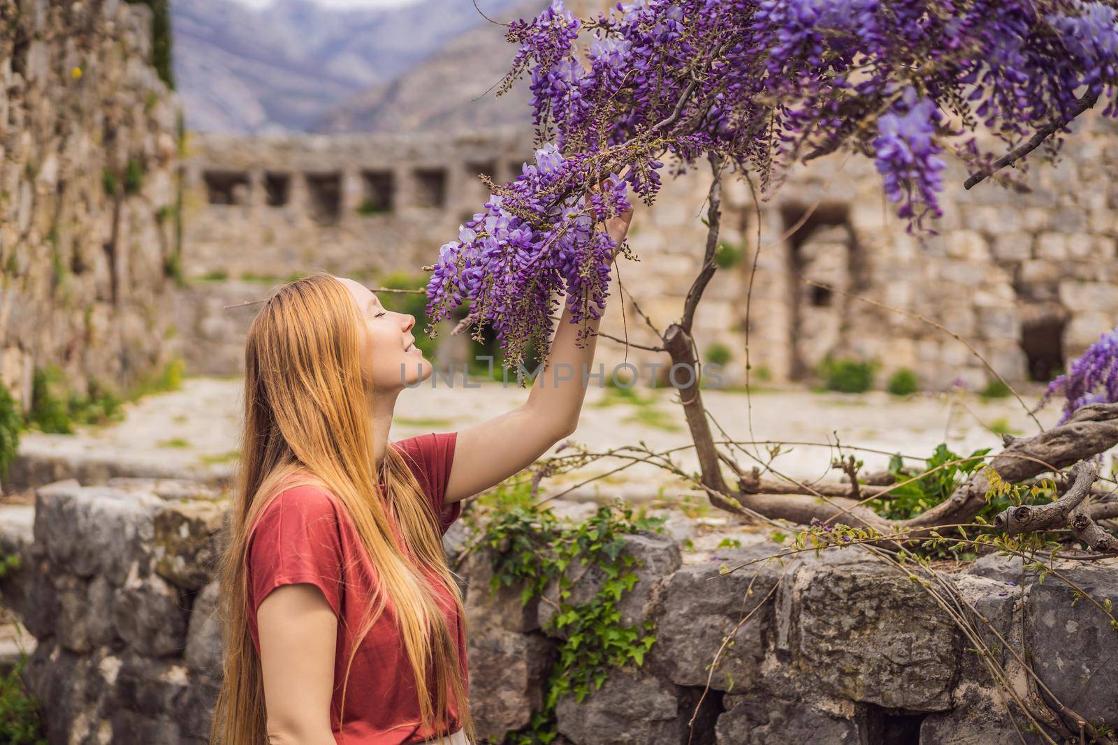 Woman tourist walks through the old town of Bar in Montenegro. Happy tourist walks in the mountains. Suburbs of the city of Bar, Montenegro, Balkans. Beautiful nature and landscape.
