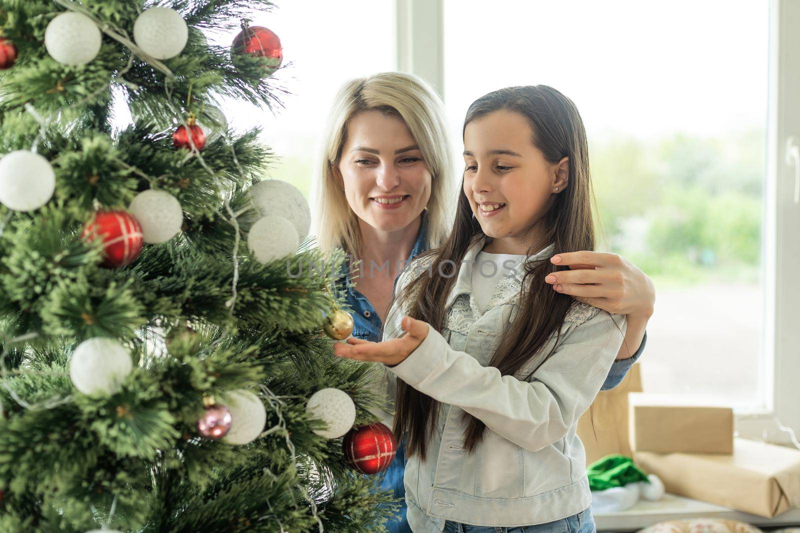 mother and daughter near the Christmas tree.