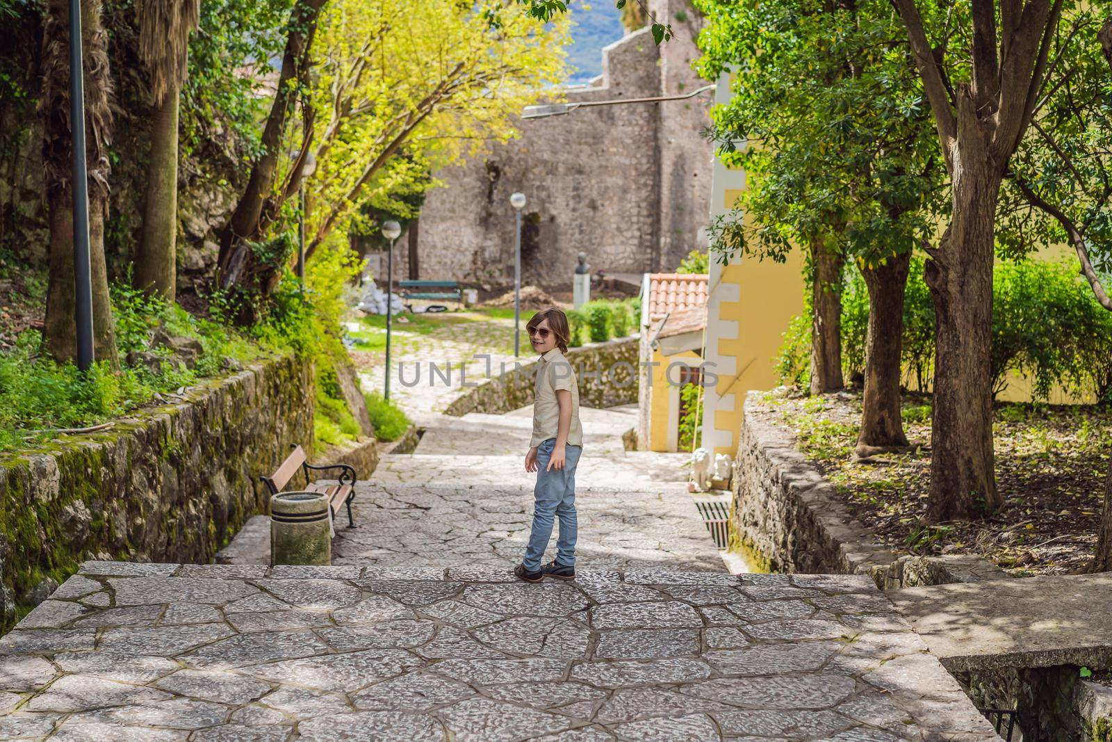 Boy tourist in Herceg Novi old town. Historical and touristic center of Herceg Novi. Montenegro.