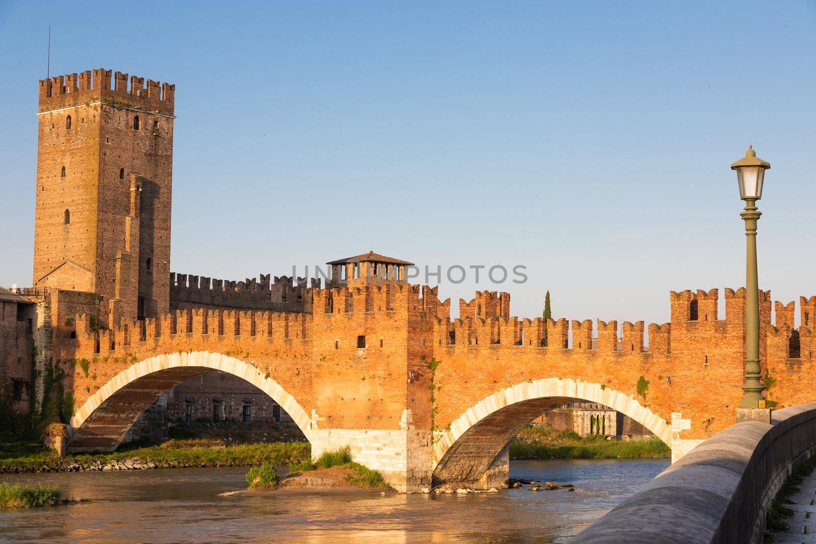 Verona, Italy. Castelvecchio bridge on Adige river. Old castle sightseeing at sunrise. by Perseomedusa