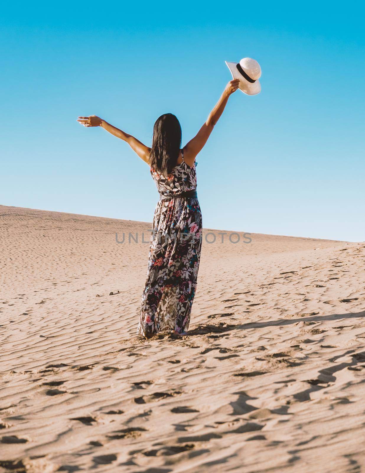 young woman at the dessert of Maspalomas sand dunes Gran Canaria during vacation at the Canary Islands. in Spain, Gran Canaria sand dunes