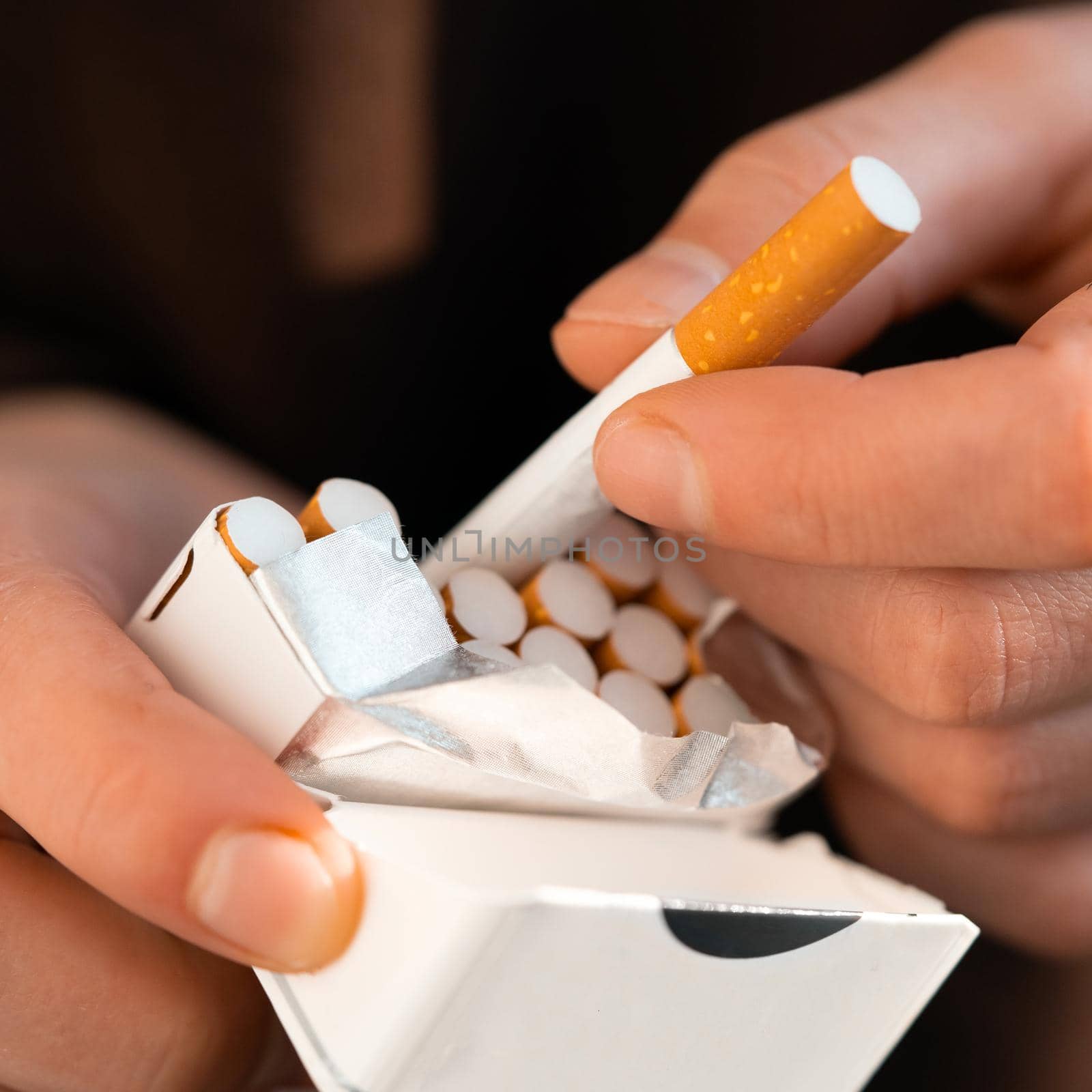 Male hands hold a pack of cigarettes, closeup view. by africapink