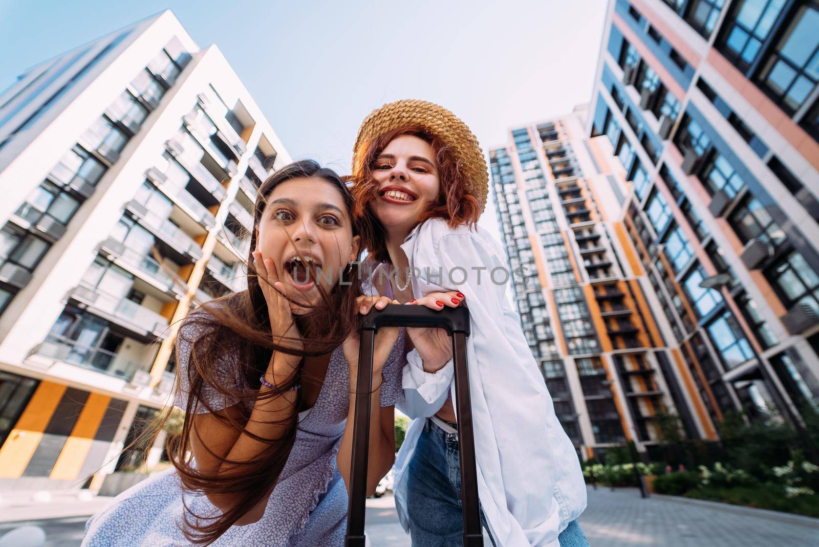 Two women are looking at the camera on the street