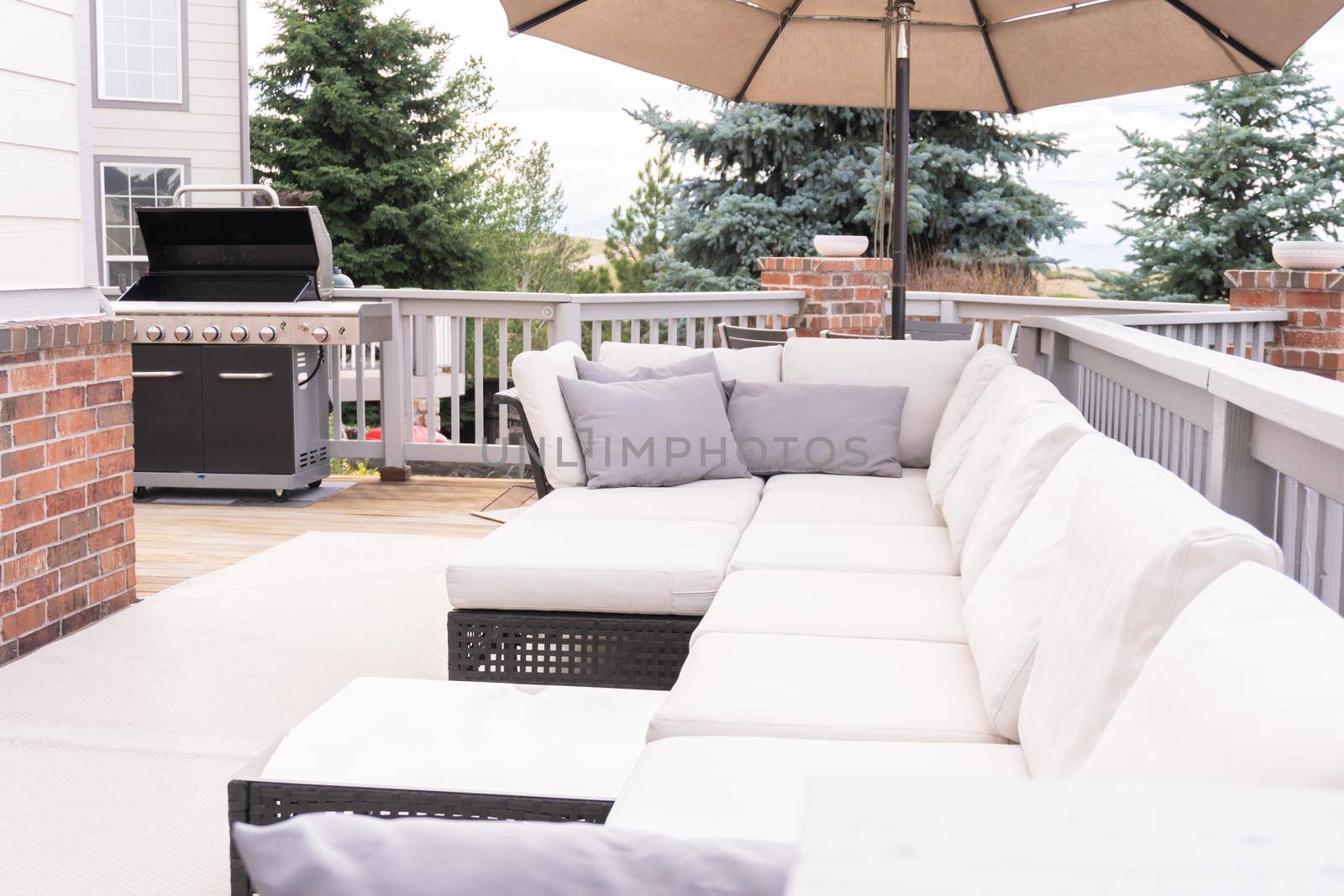 Patio of a luxury single-family home furnished with modern furniture.