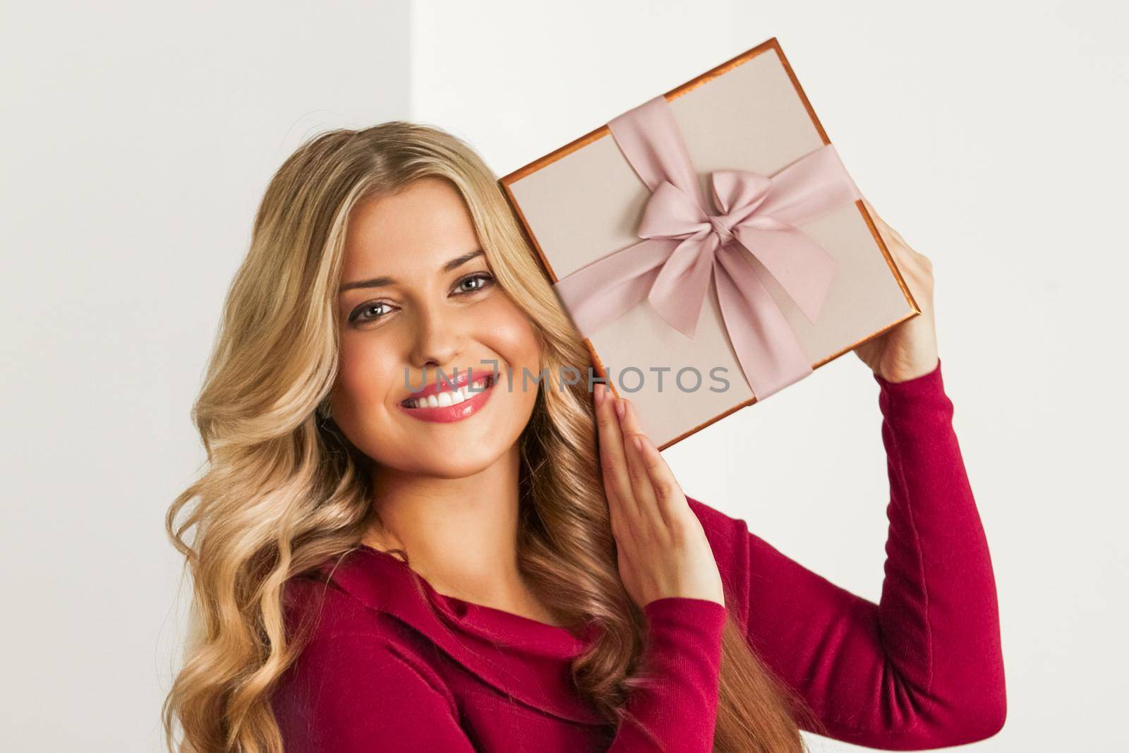 Happy woman holding a gift for birthday, anniversary, wedding, Valentines day or Christmas, luxury holiday present or beauty box subscription delivery by Anneleven